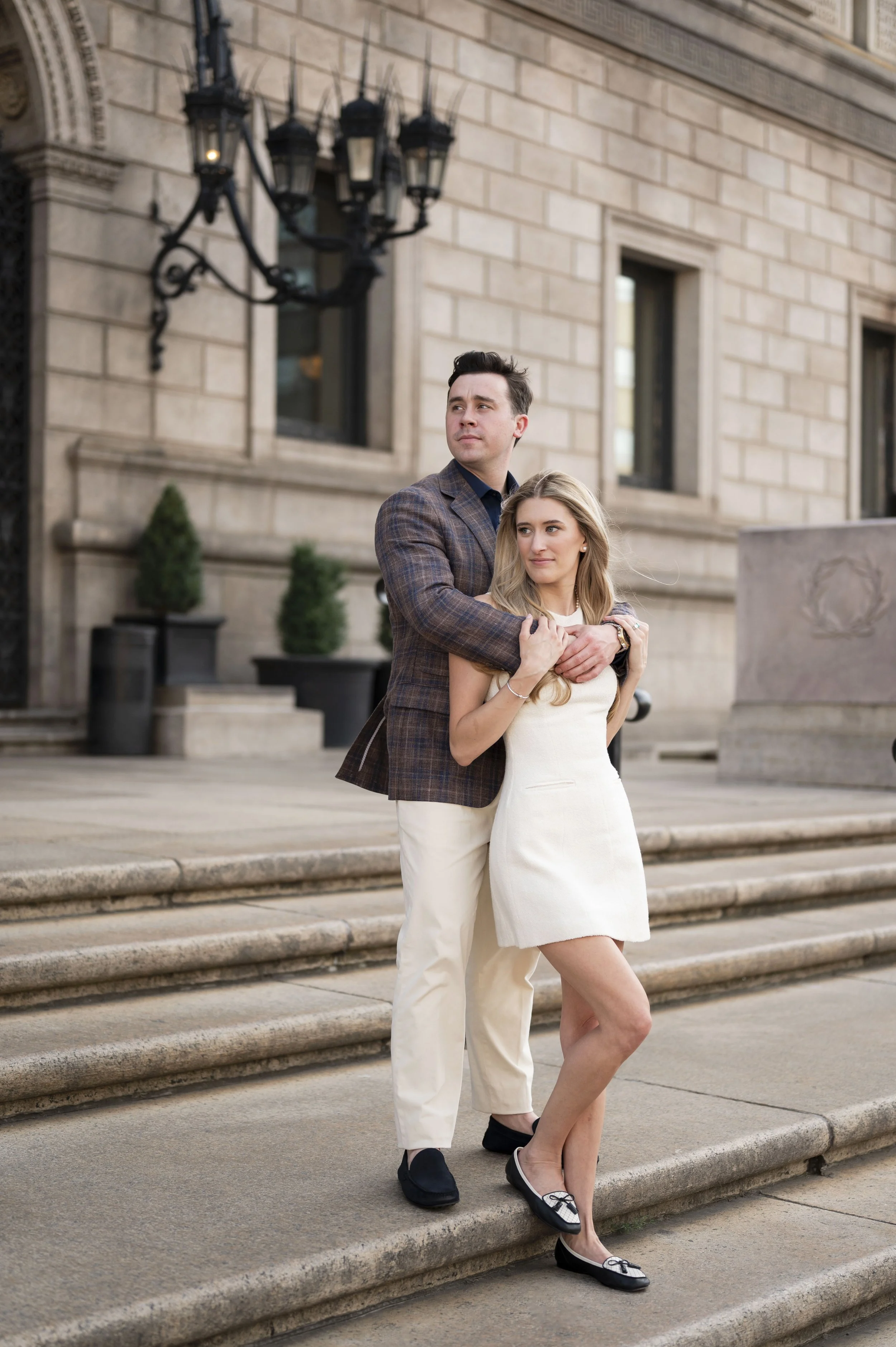 Cathryn and Brendan hugging at the stairs of boston public library during their engagement session