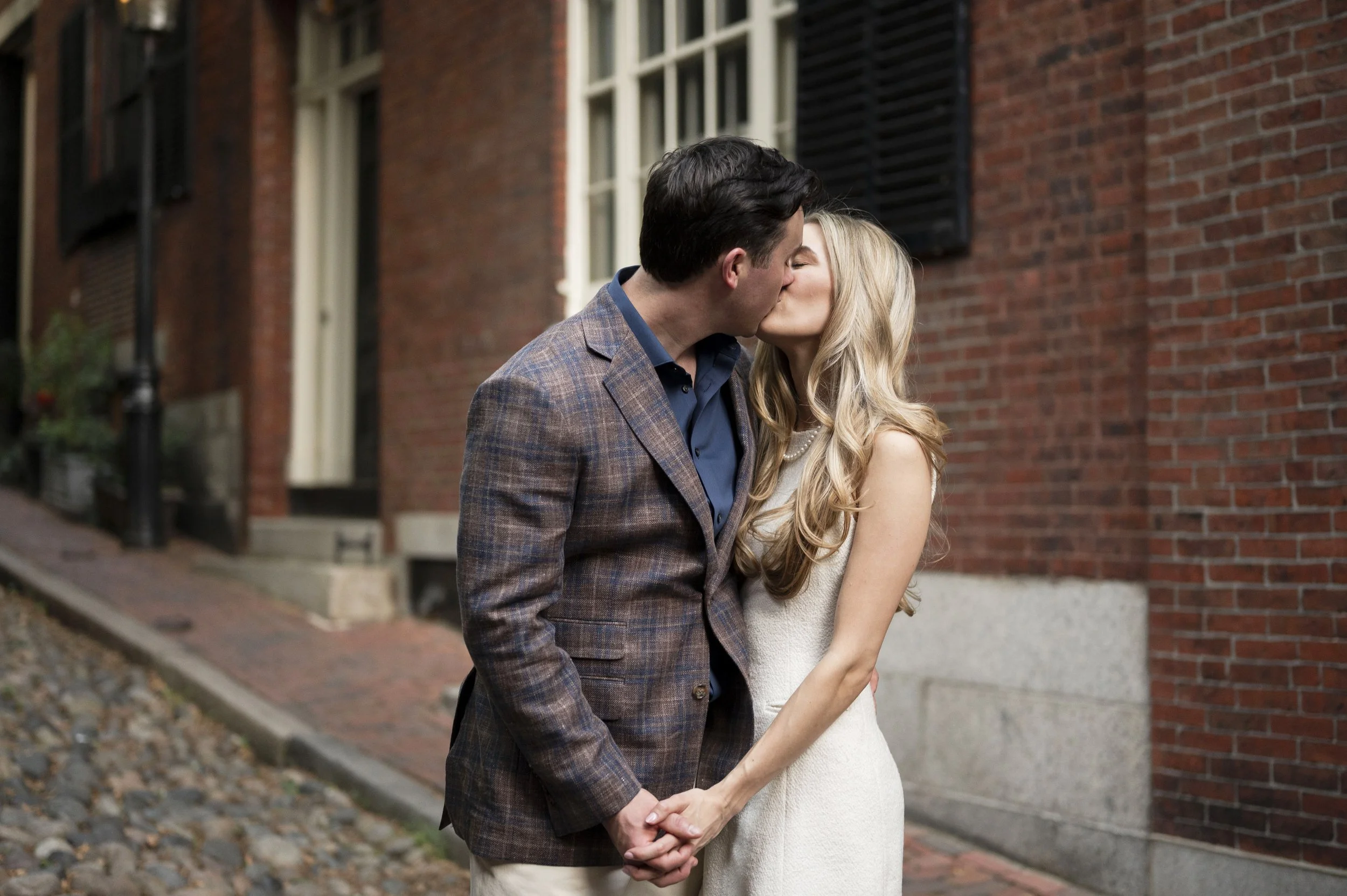 Cathryn and Brendan kissing at Acorn street in Boston during their engagement sessions