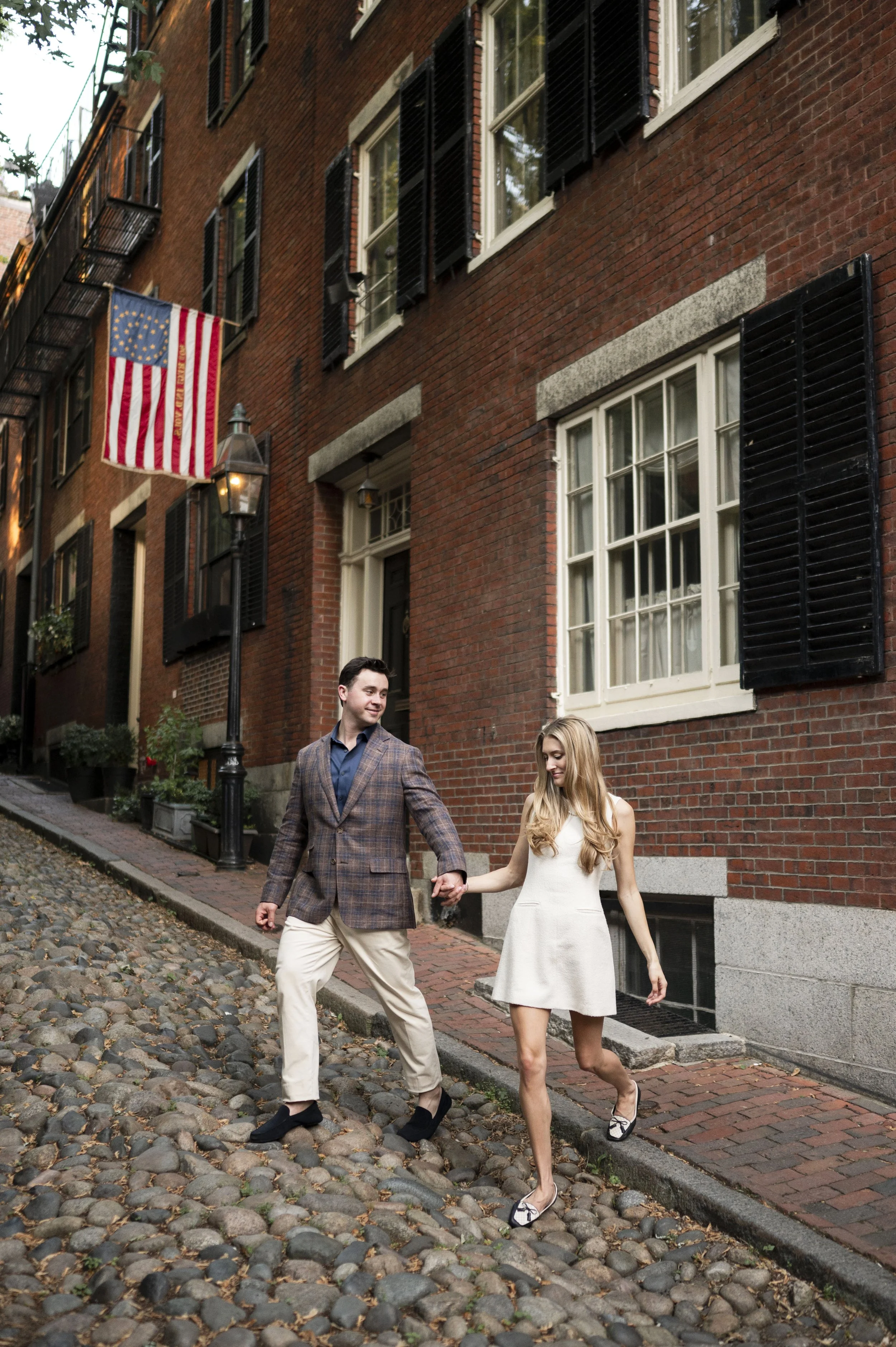 Cathryn and Brendan walking at Acorn street in Boston during their engagement sessions
