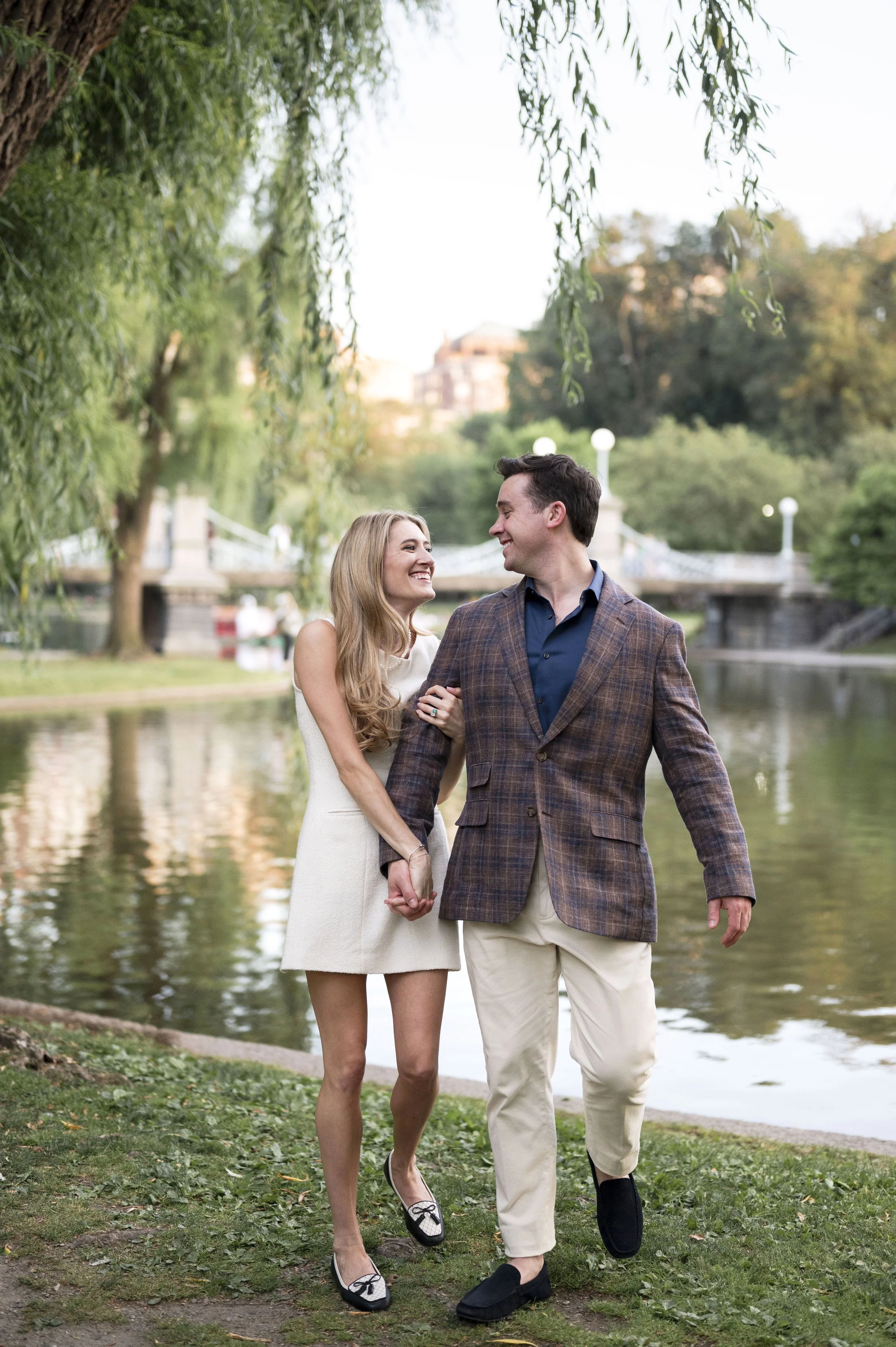 Cathryn and Brendan walking through Boston Public garden during their engagement session