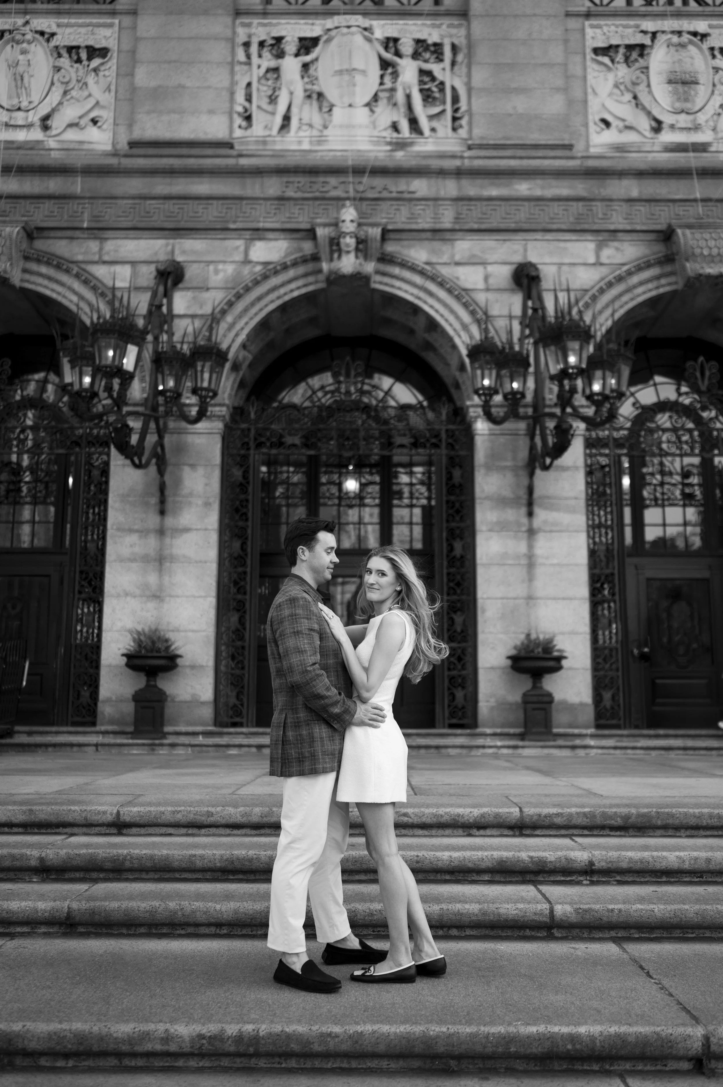 Cathryn and Brendan stabding at the steps of boston public library during their engagement session