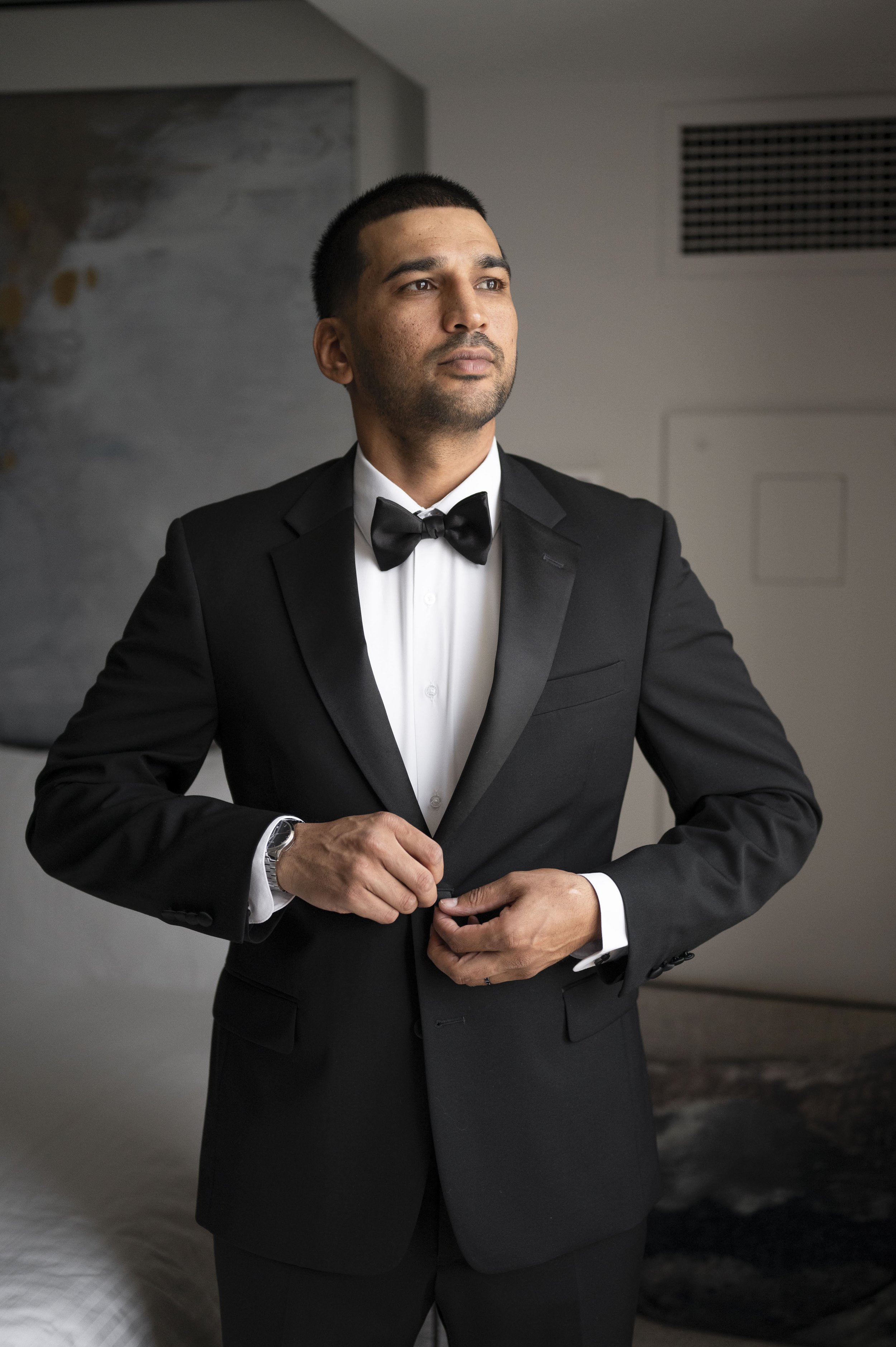 saby  closing his jacket at the getting ready suite Loews hotel miami beach