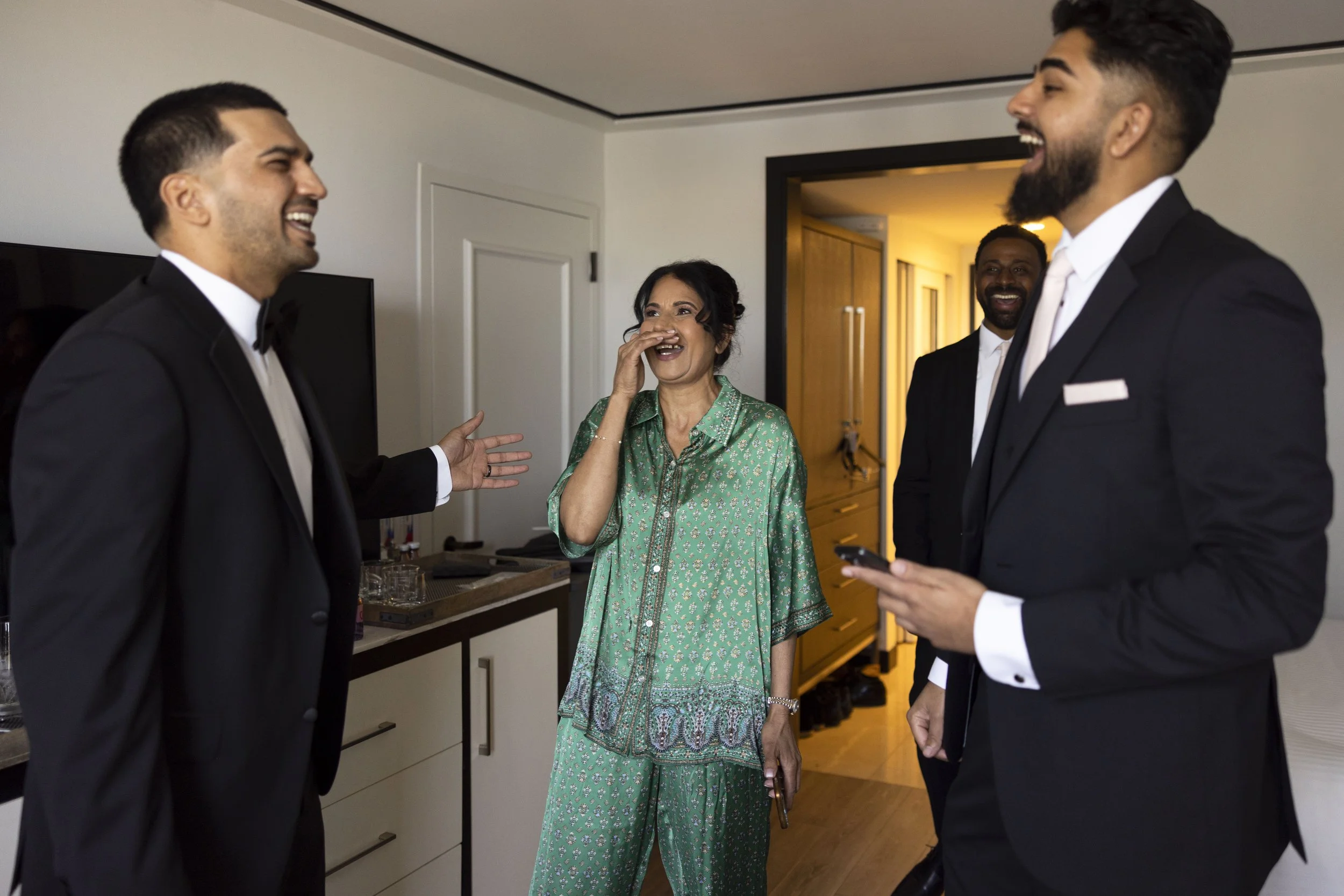Saby laughing with her mother and brother in the getting ready suite of the Loews hotel miami beach