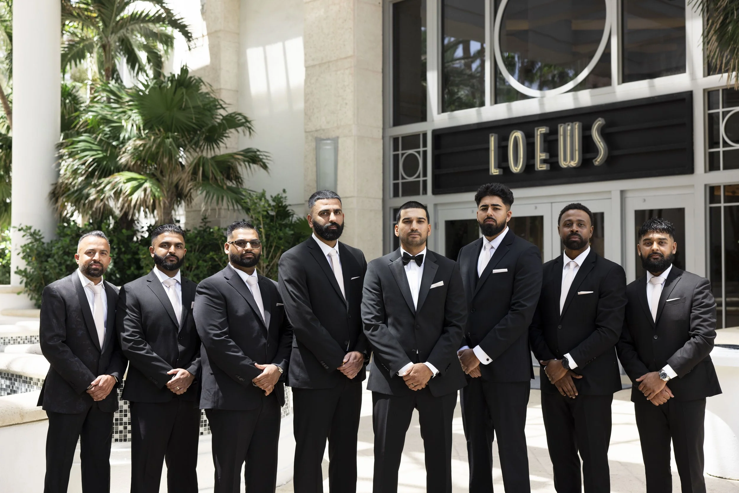 groom and groomsmen standing in front of the Loews hotel miami beach