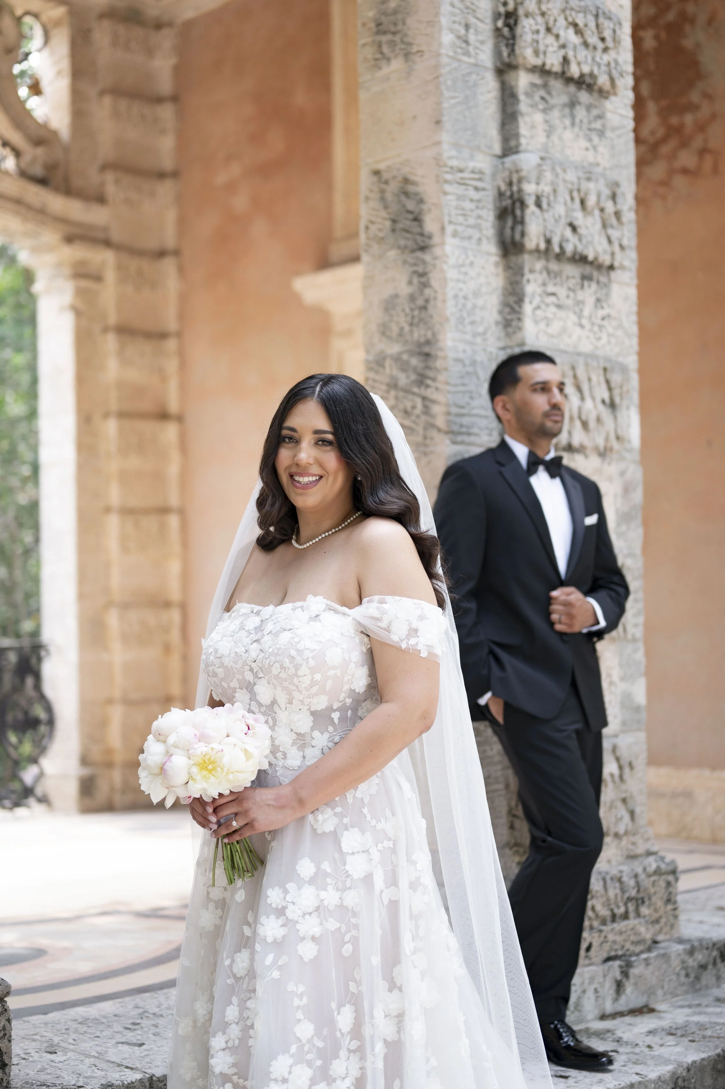 bride and groom posing at the gardens of Vizcaya museum