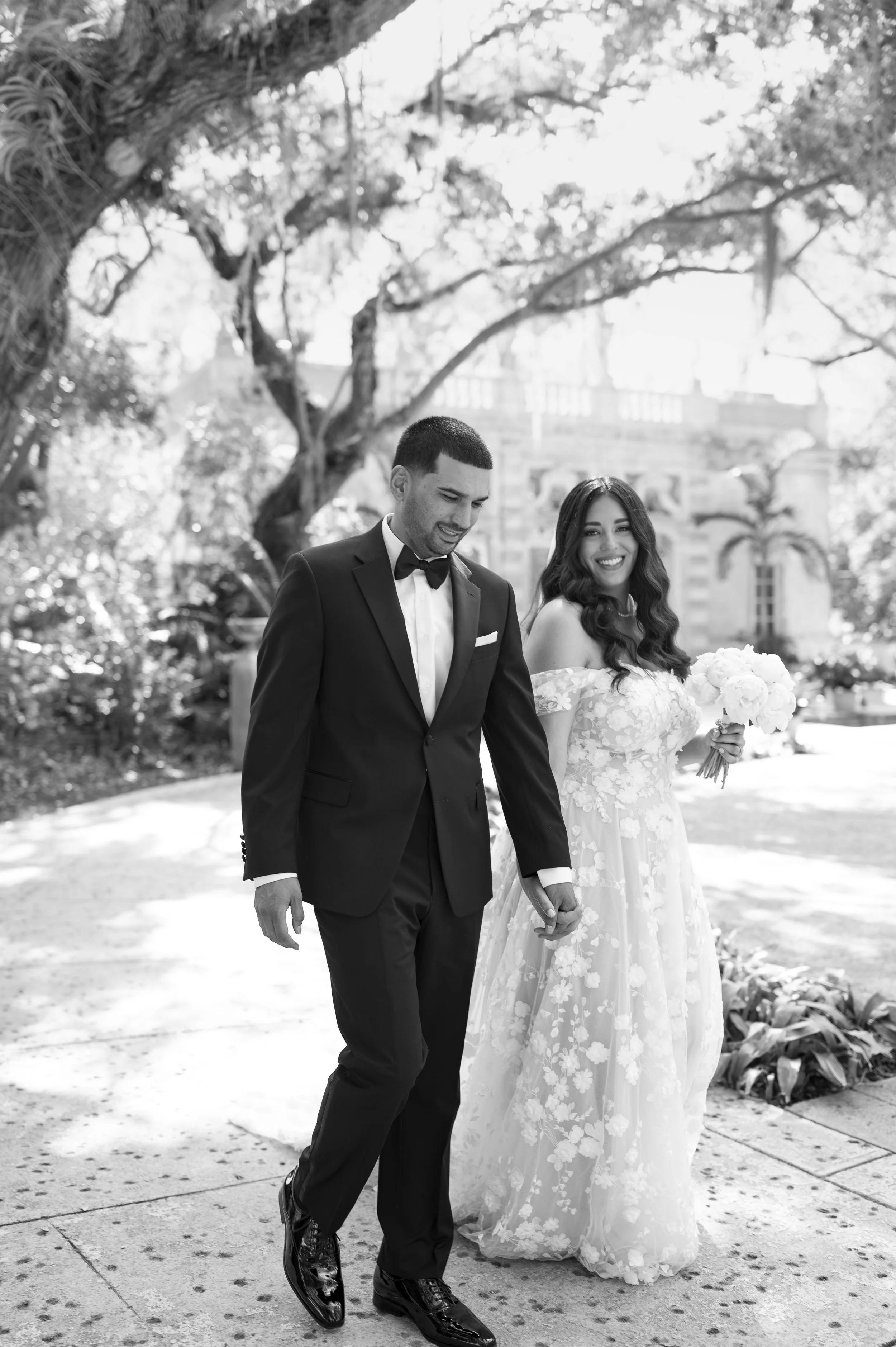 bride and groom walking through the gardens of Vizcaya museum