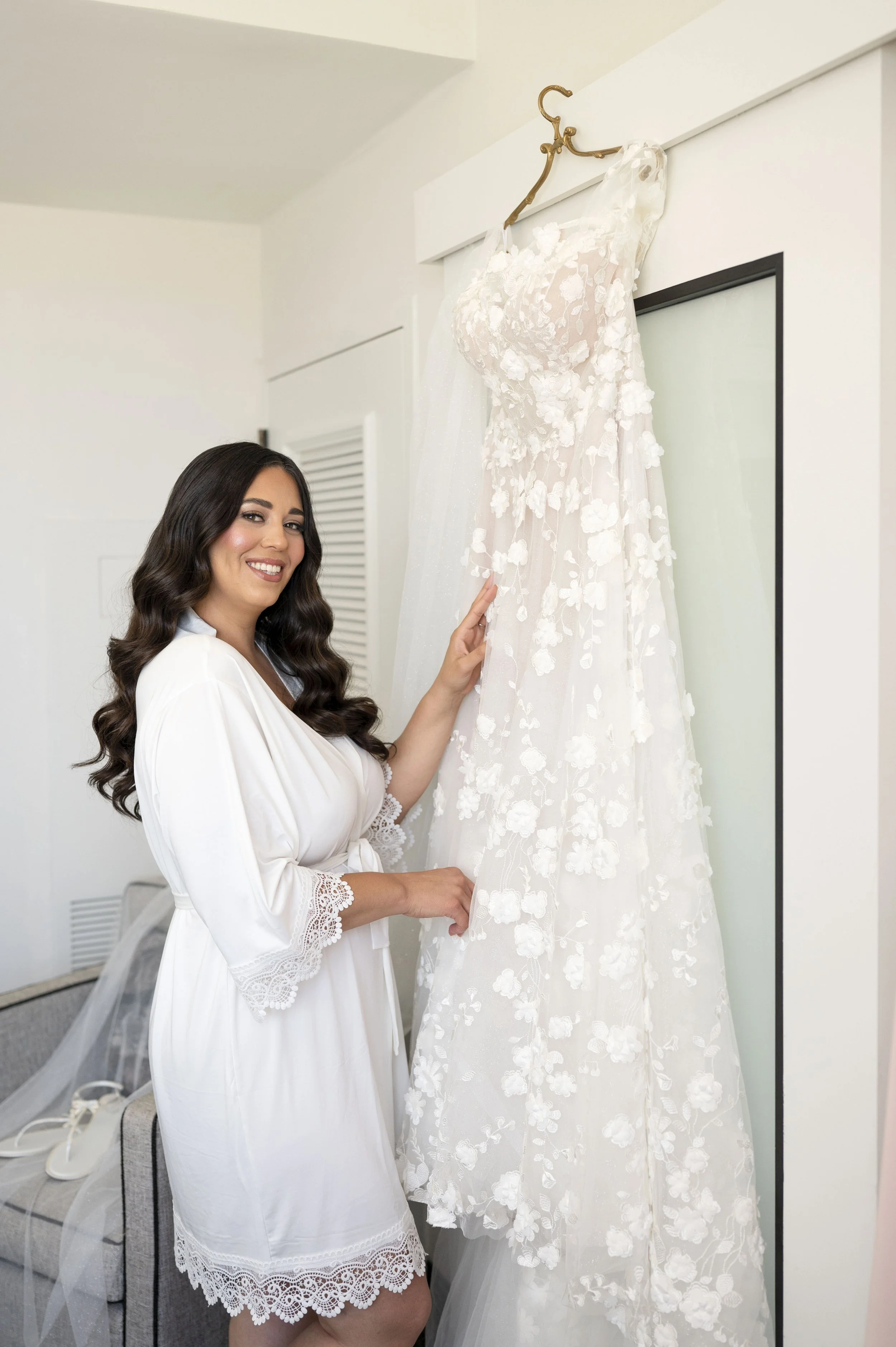 Christina looking at her dress at the Loews hotel south beach on her wedding day