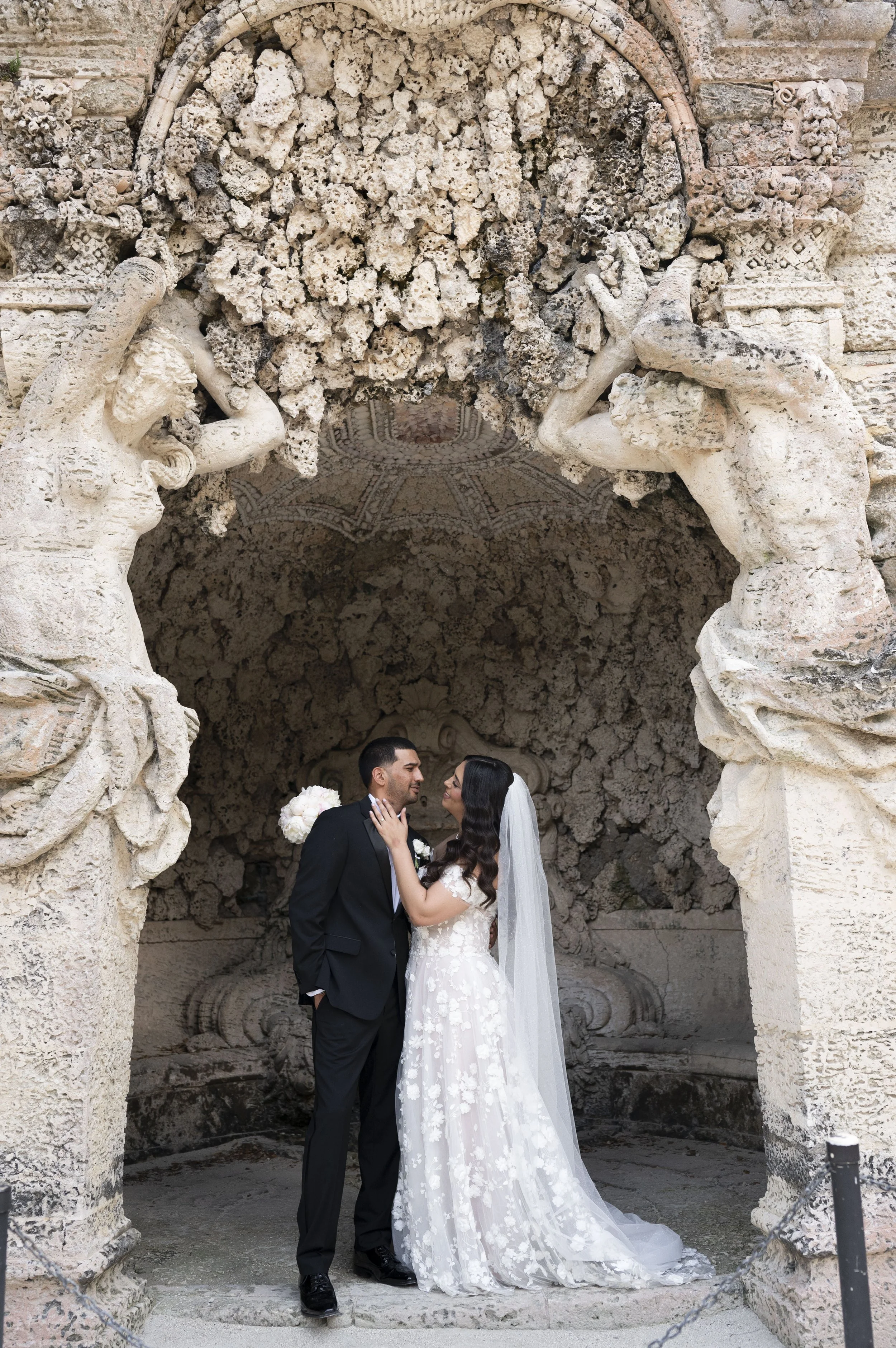 classic couple kissing at the vizcaya museum and gardens during their wedding day