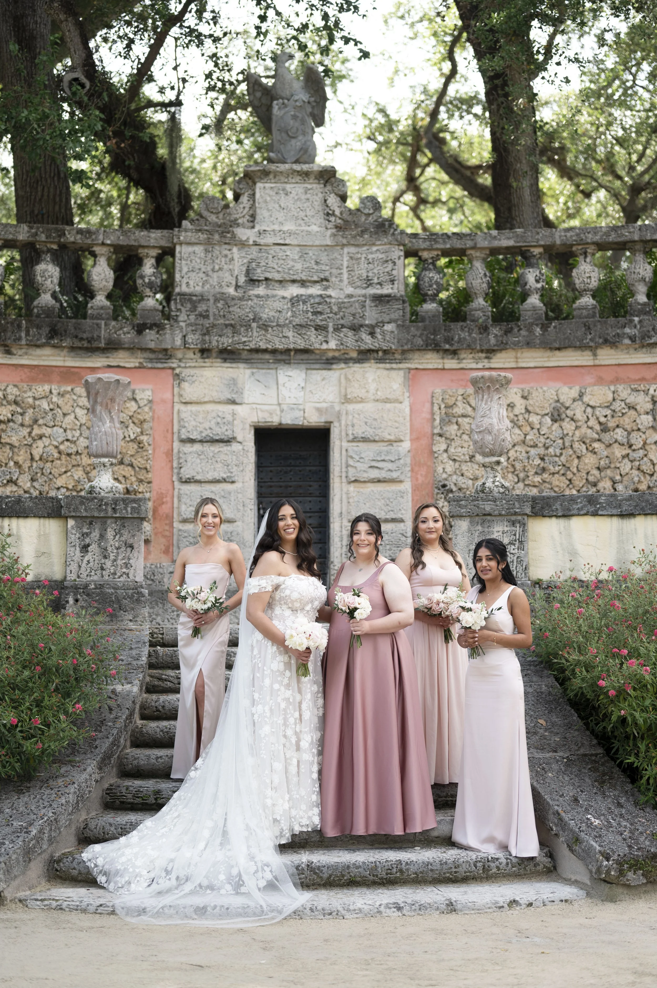 bride and bridesmaids standing at the Vizcaya museum and gardens