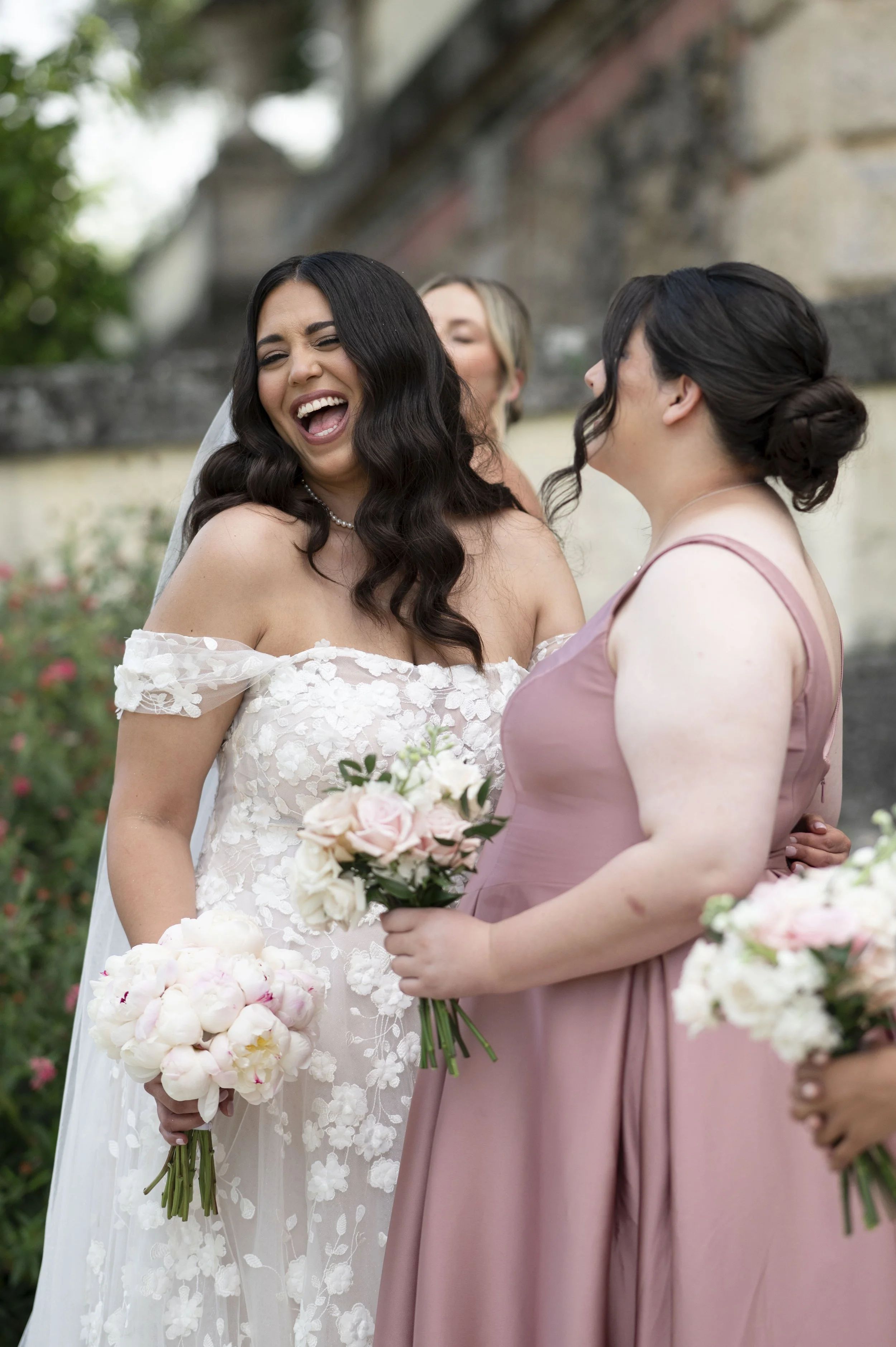 bride laughing with her bridesmaids in the Vizcaya museum and garderns.
