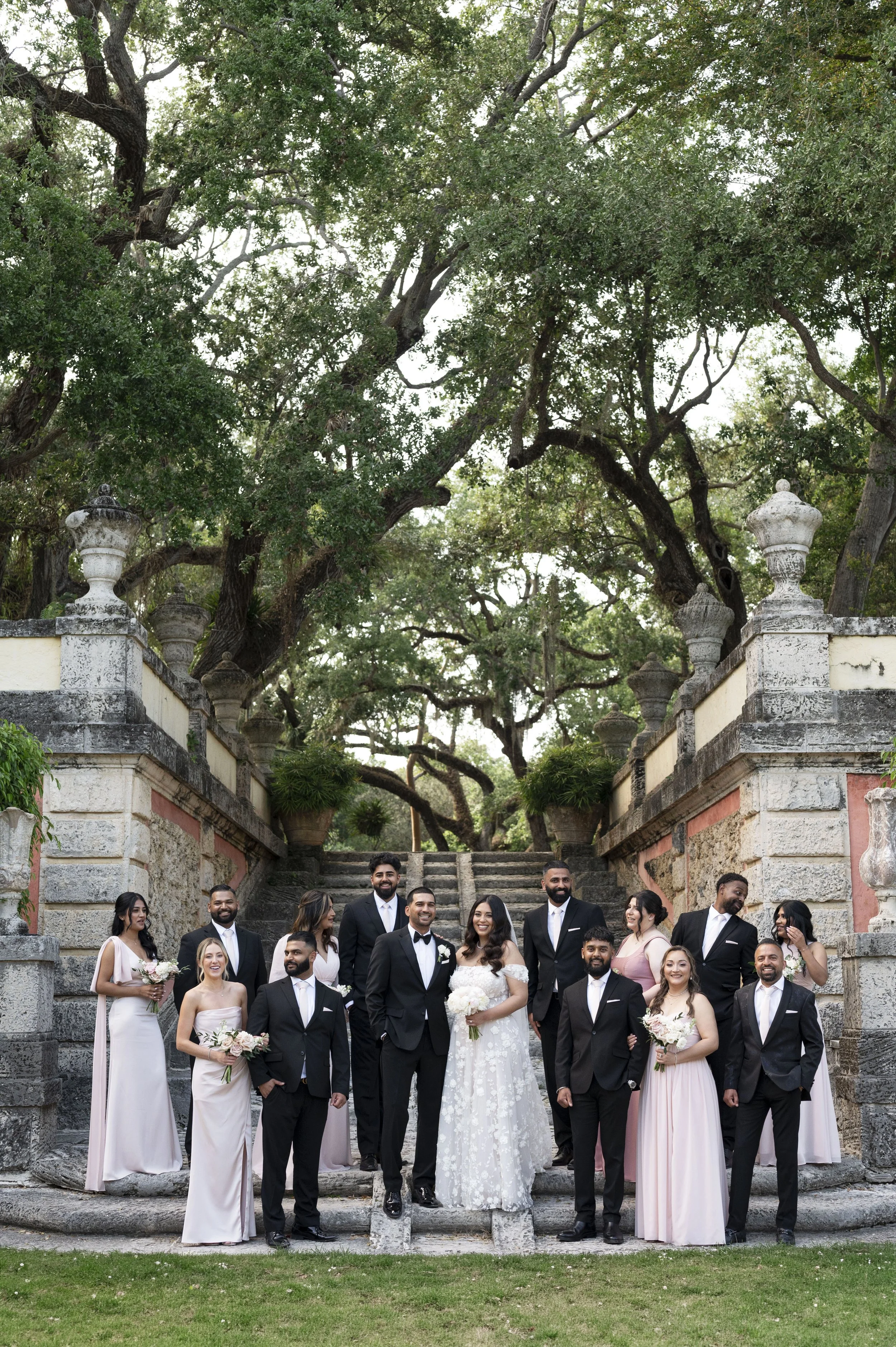 Bridal Party standing in the stairs of the vizcaya museum and gardens  during their wedding day