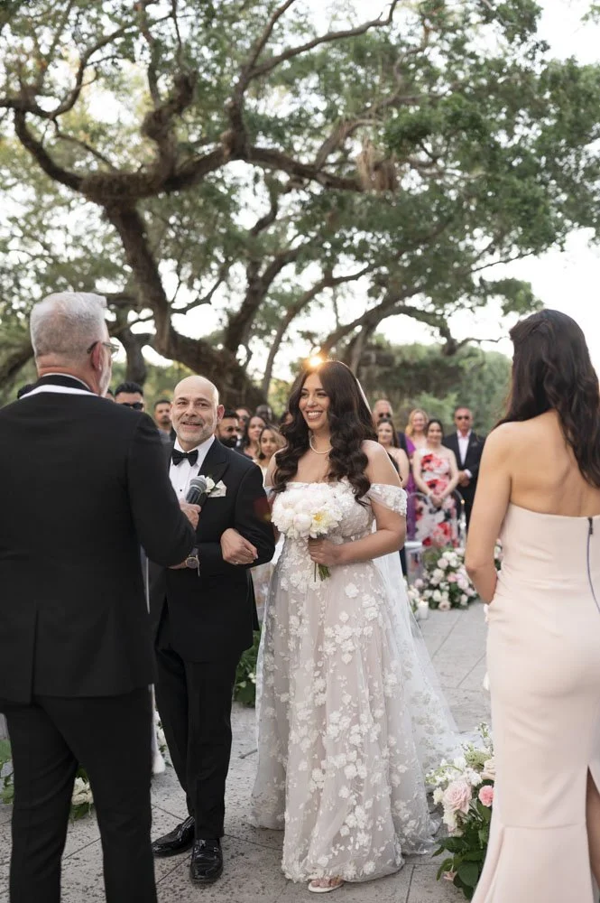 father hands her daughter to the groom on the ceremony at the vizcaya museum and gardens in miami