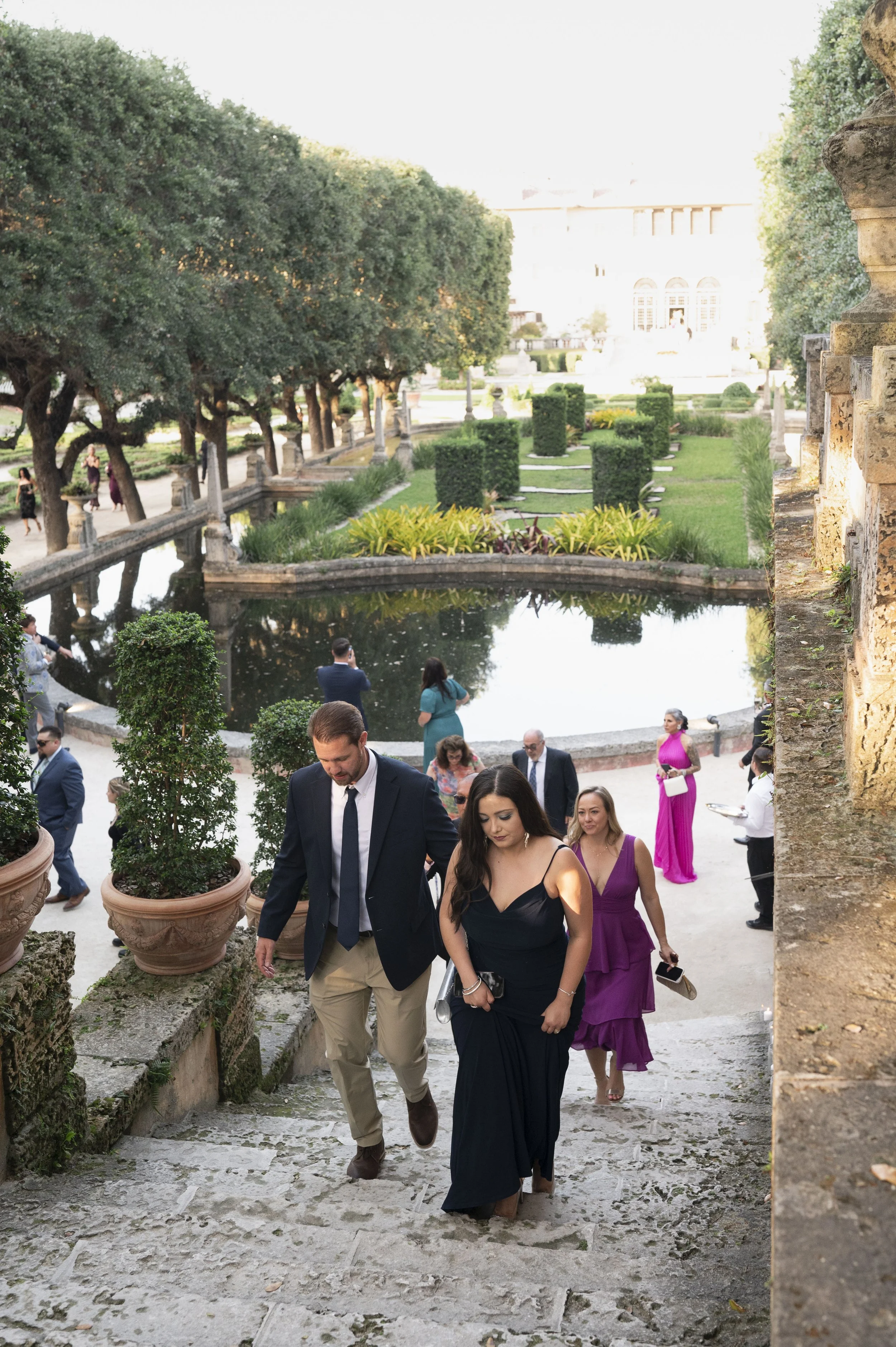 guest walking towards the ceremony at the vizcaya museum and gardens in miami