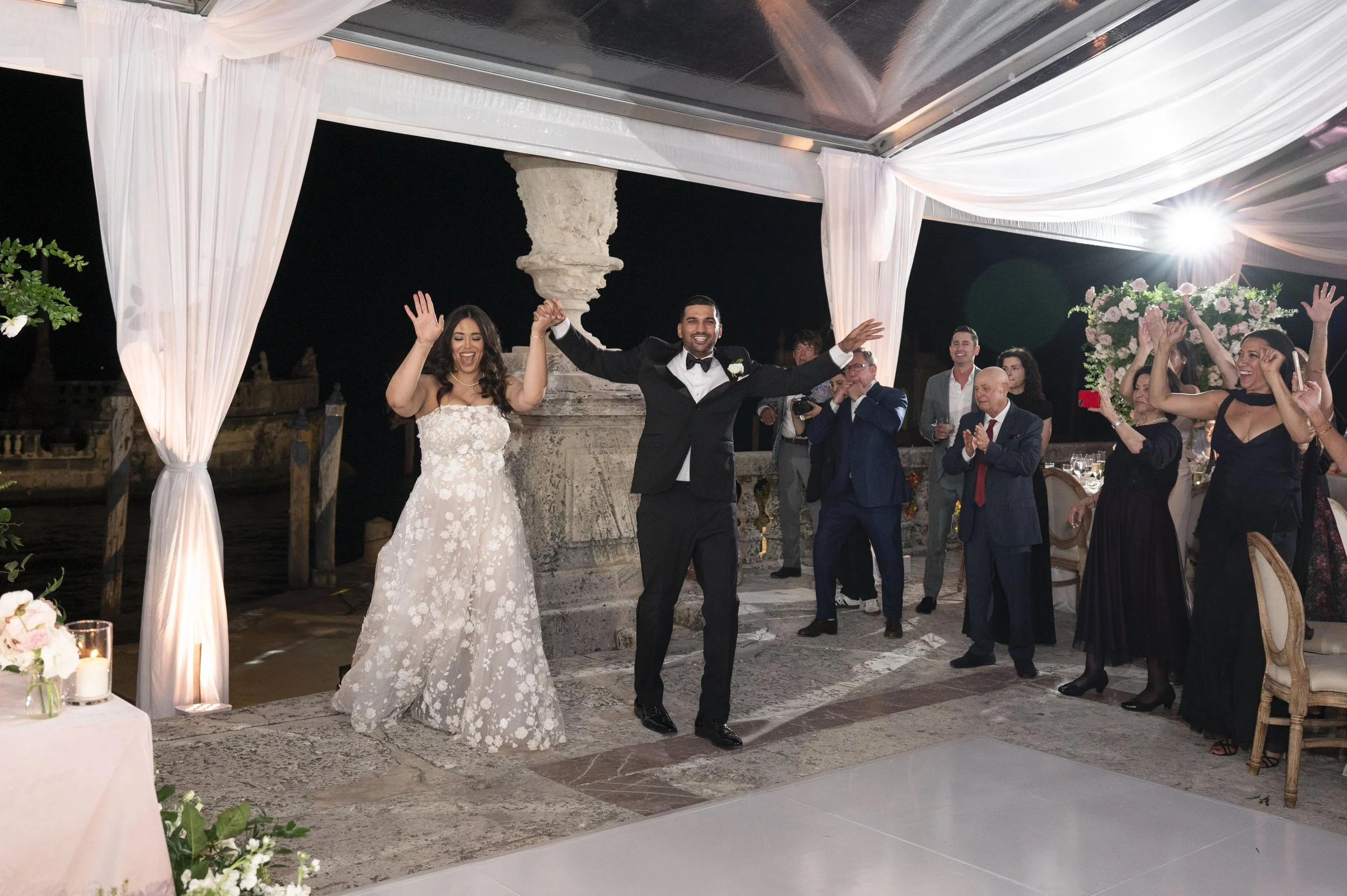 bride and groom entering their reception party in the Vizcaya museum