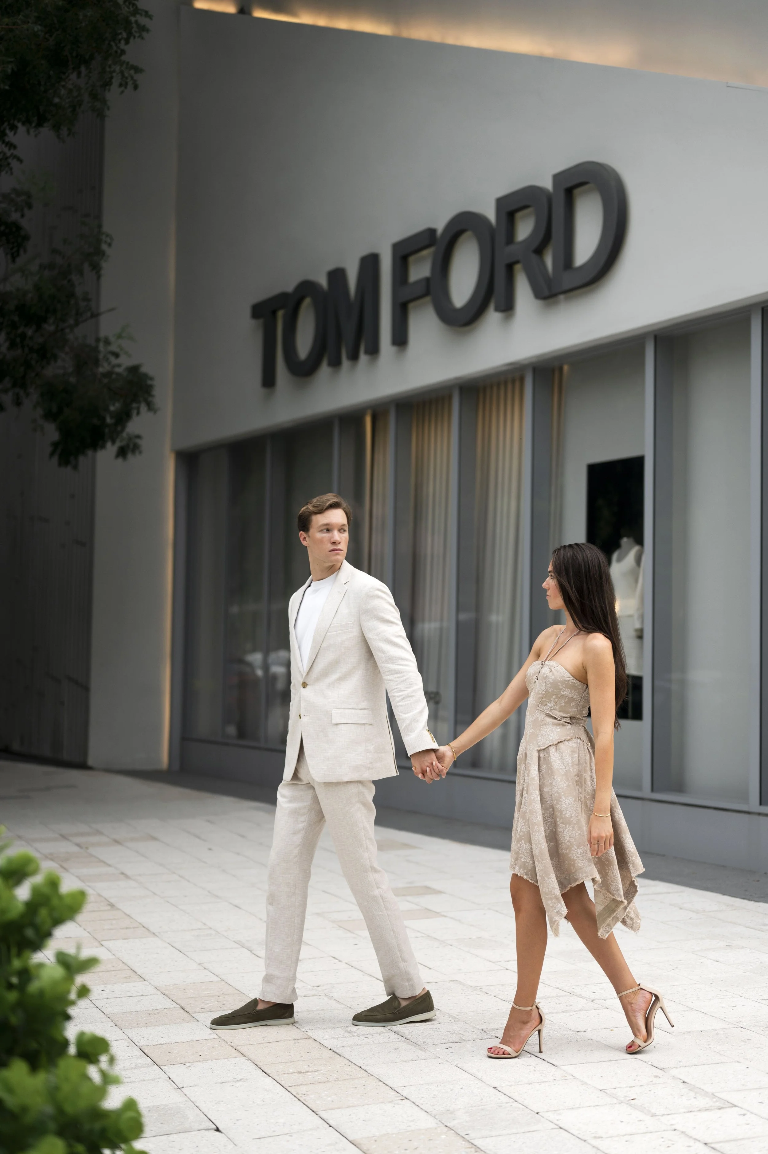 Rachel and Travis walking throught the streets of miami design district during their engagement session