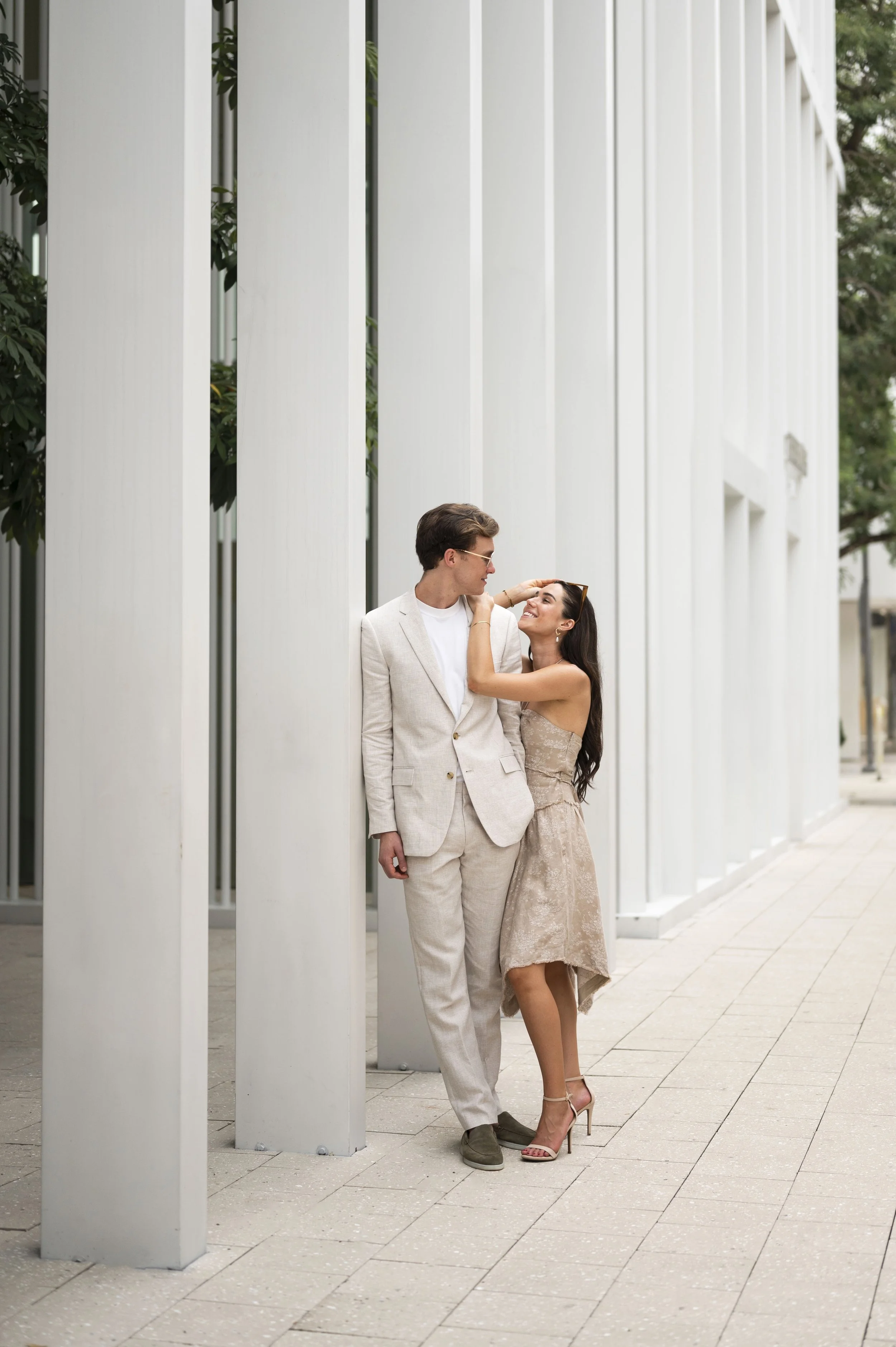 rachel and travis posing at the miami design district shops area during their engagement session