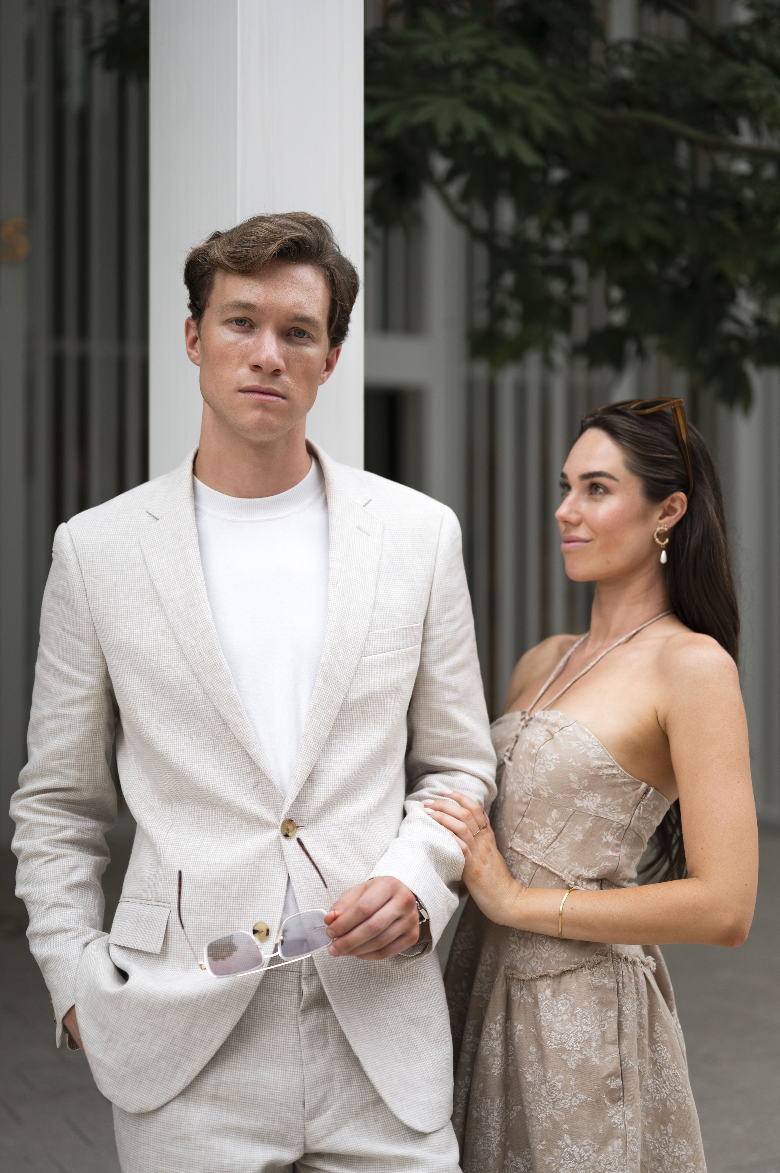 Travis and Rachel standing in front of the Hermes store in miami during their engagement session
