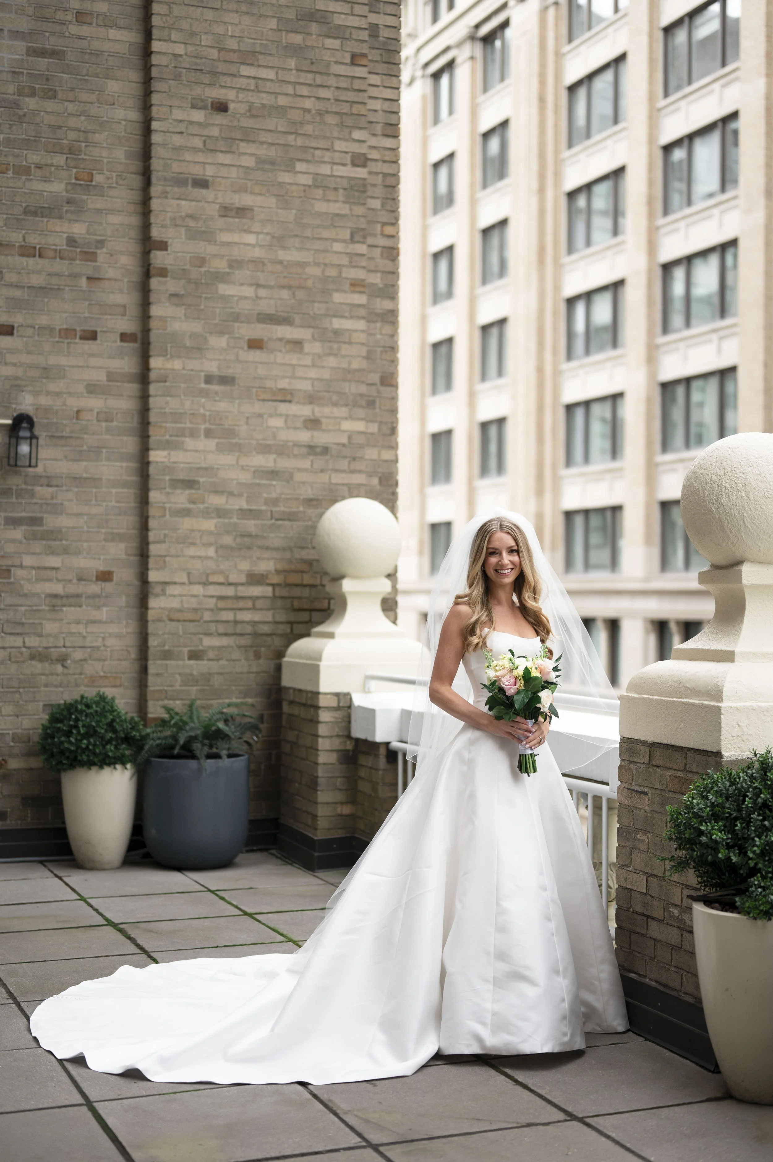 bride posing at the park plaza terrace on her wedding day