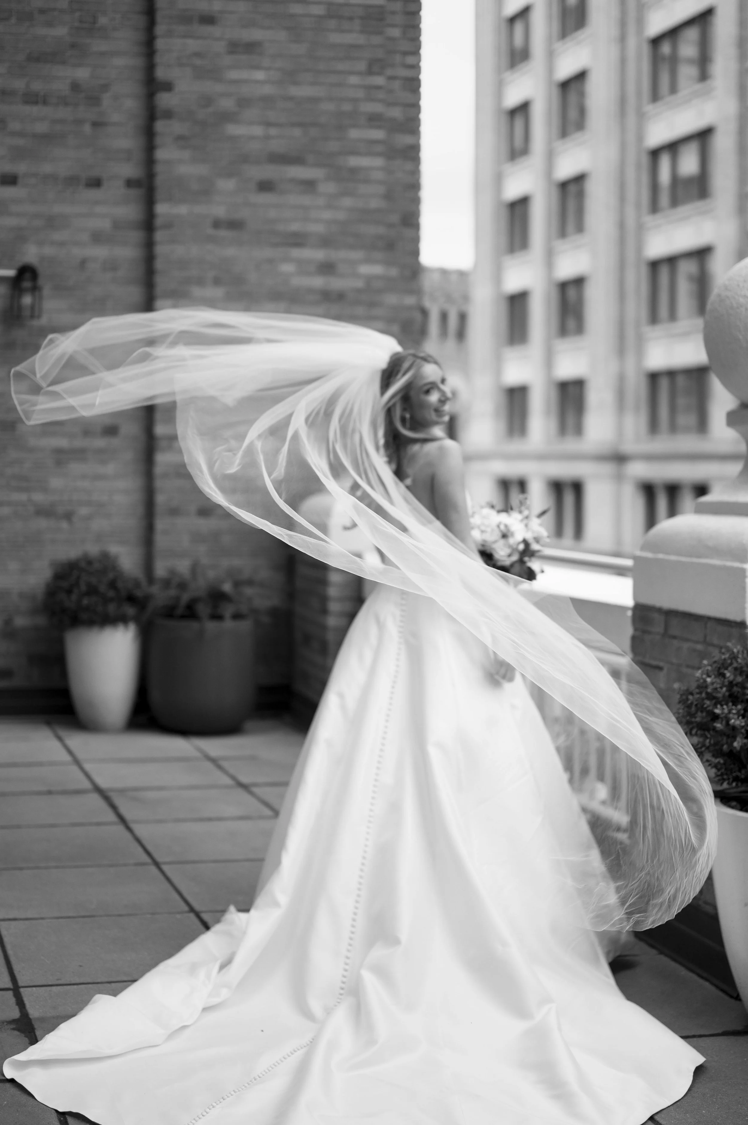 bride playing with her dress in a terrace of the park plaza