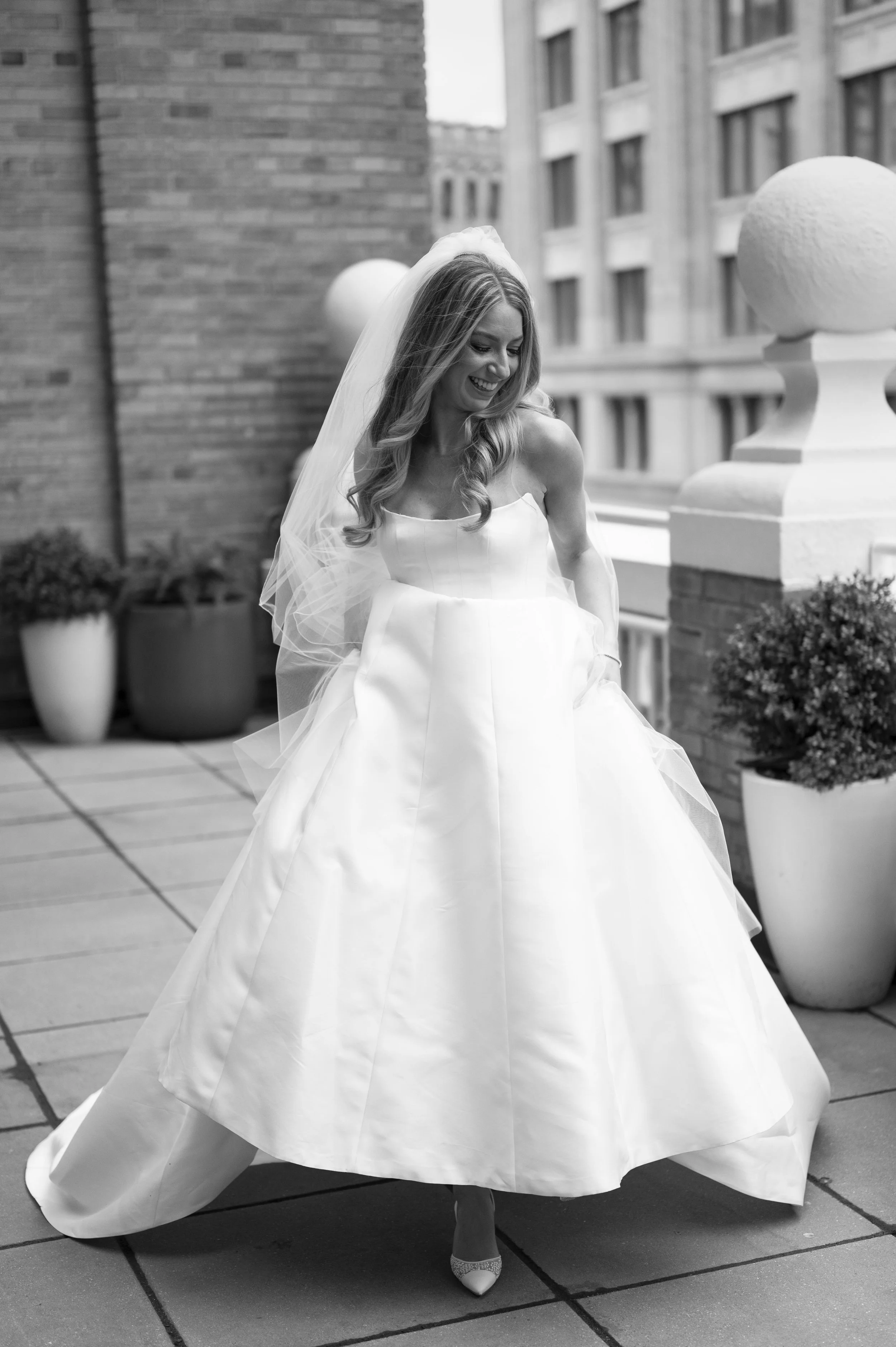 bride running towards the camera holding her dress 