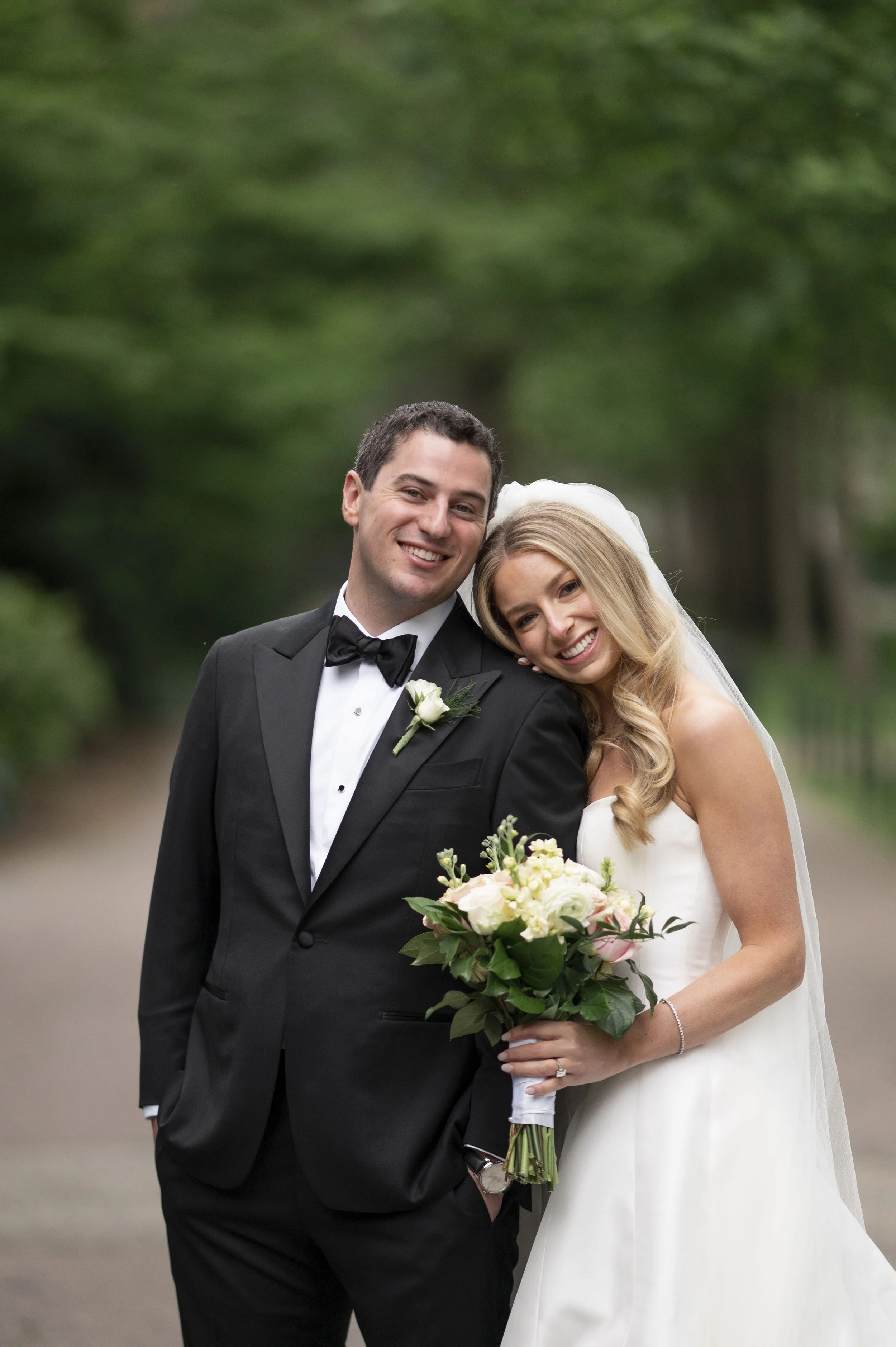 groom and bride pose together at the boston public garde