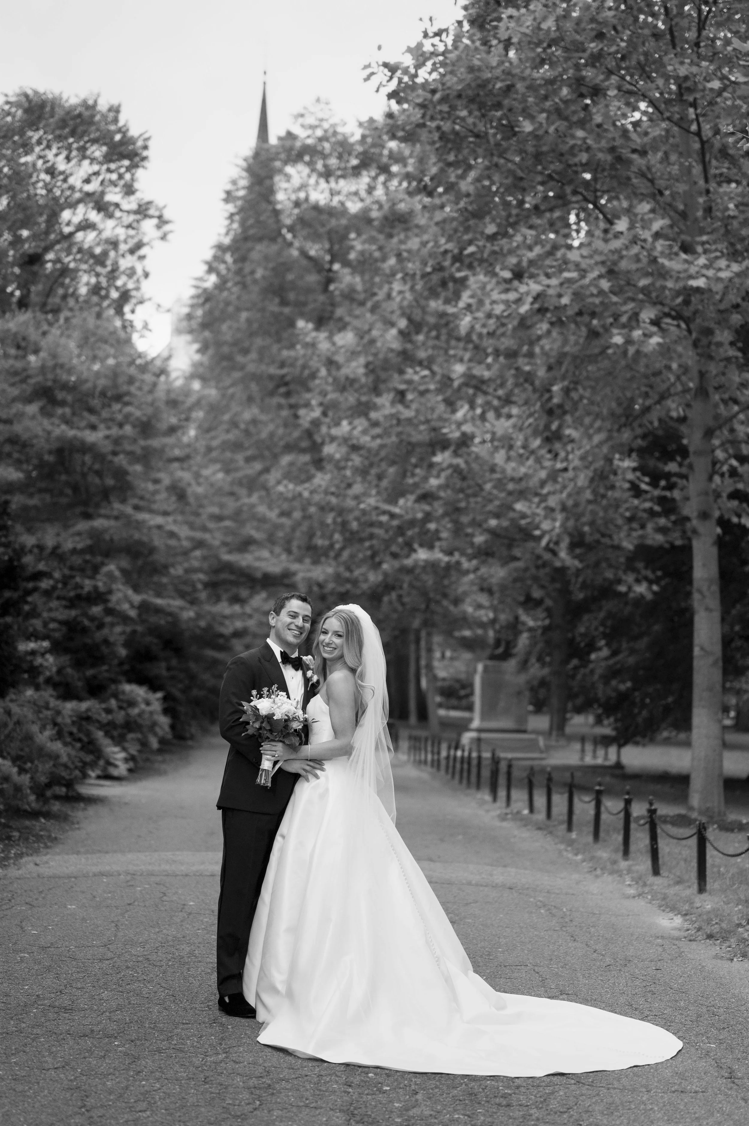 bride and groom pose for the camera at the boston public garden