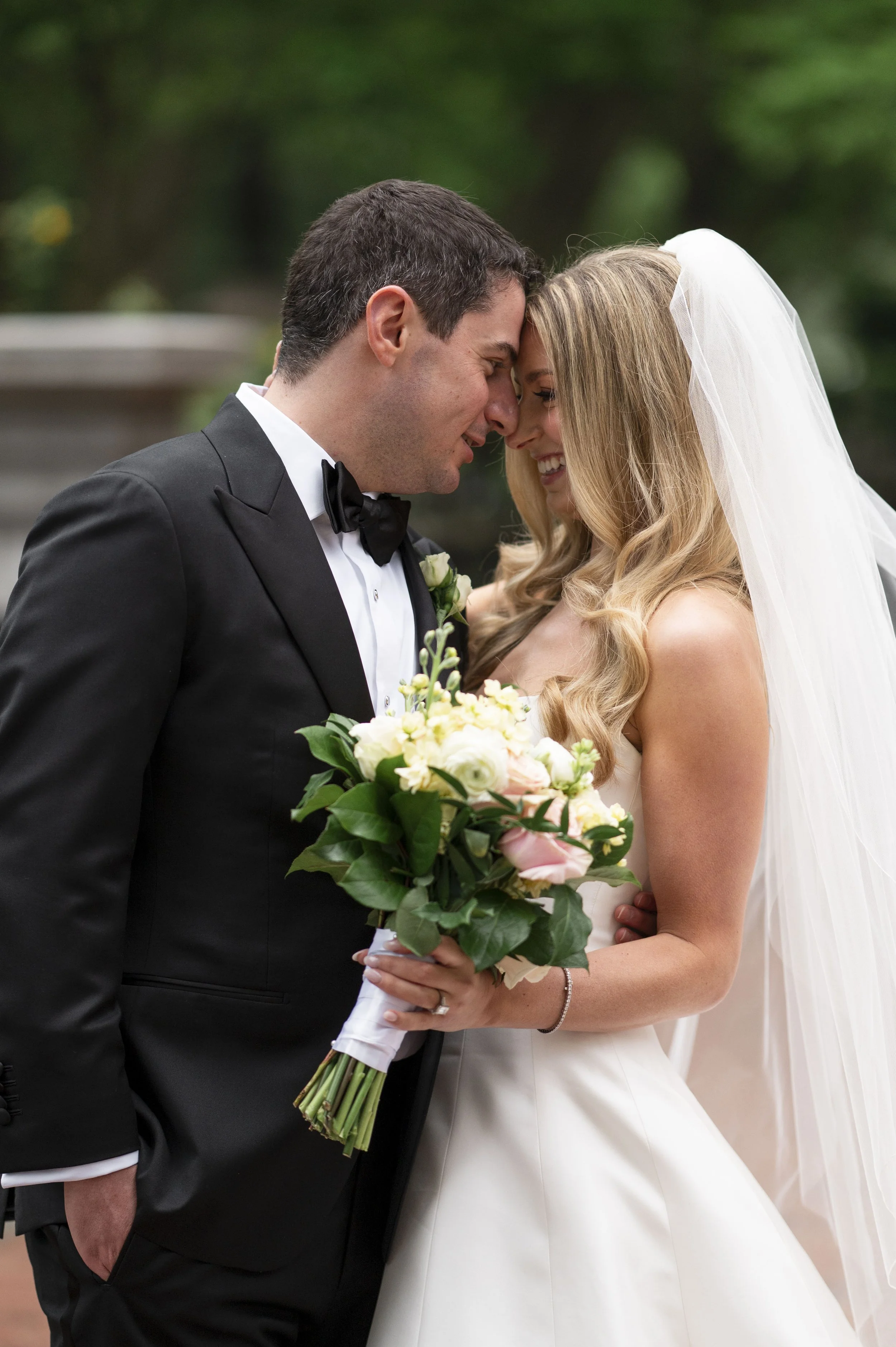 groom and bride putting their forheads together as they smile to eachother