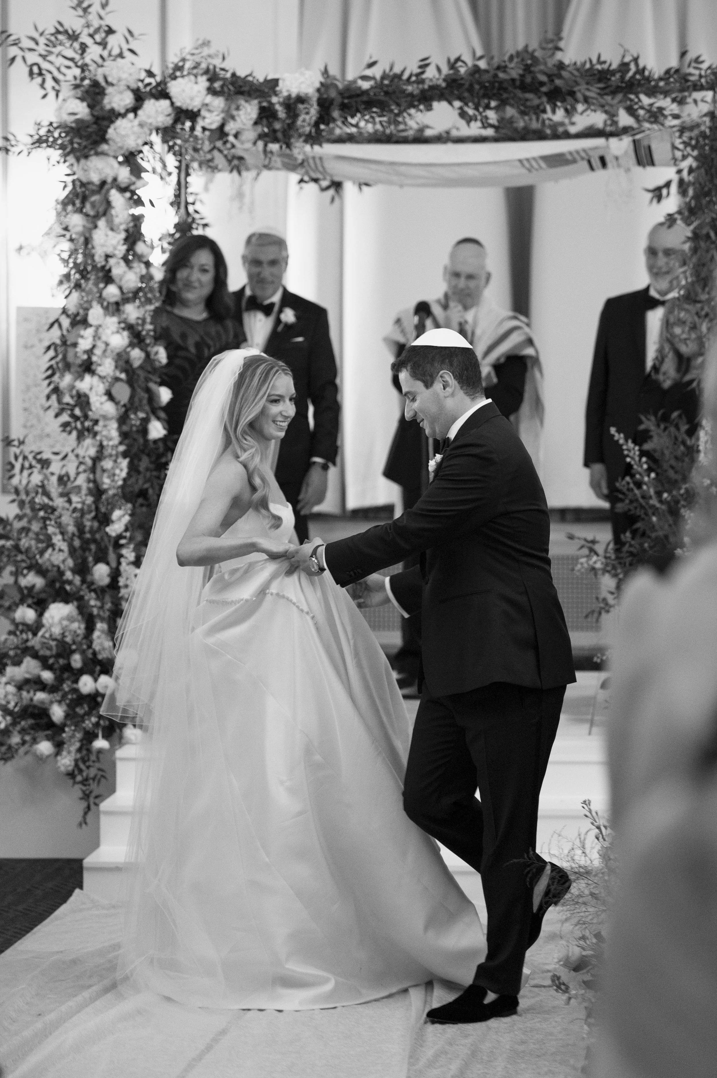 bride and groom holding hands during their jewish wedding at the park plaza hotel boston