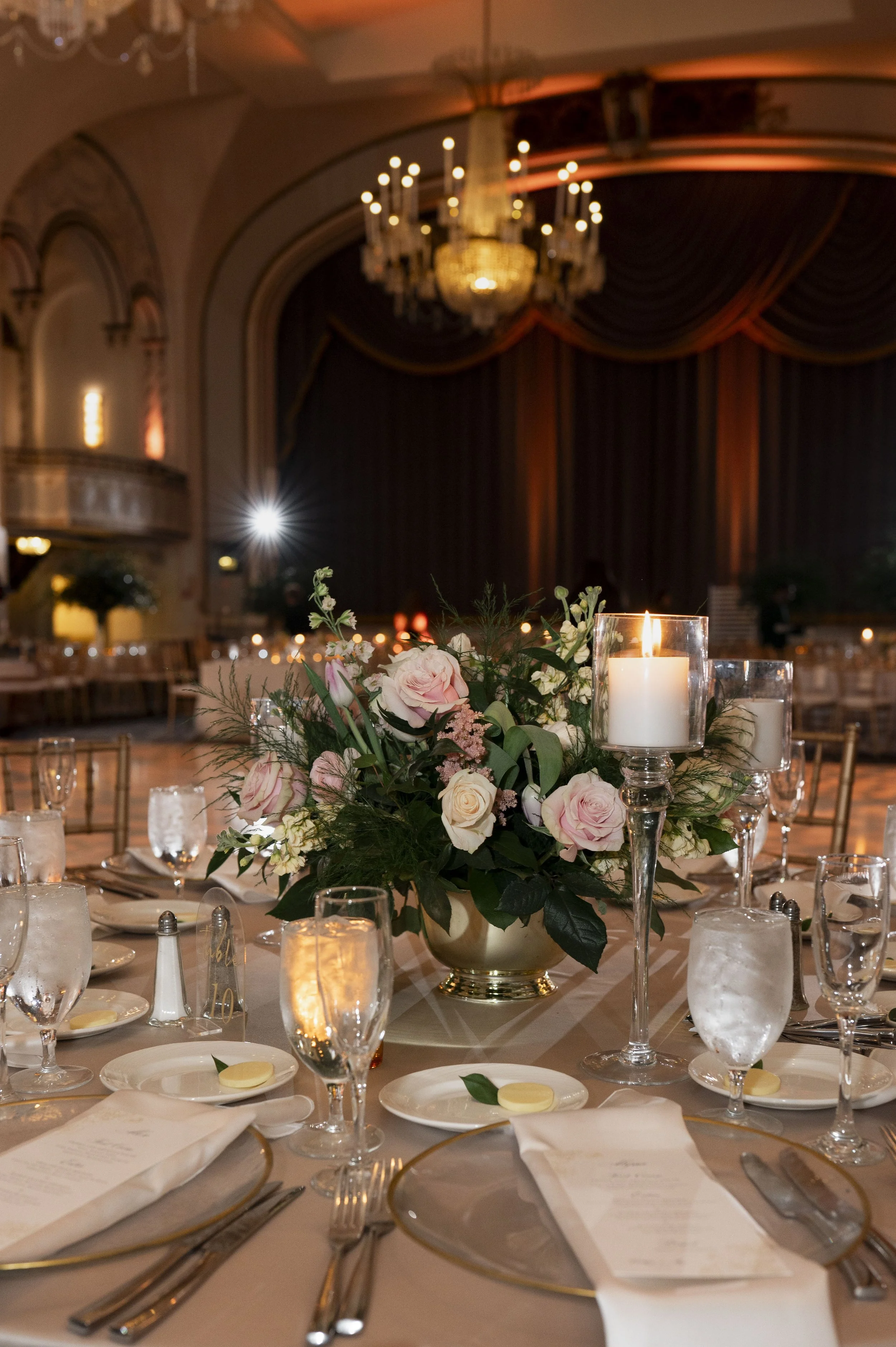 luxiry wedding reception decor at the boston park plaza featuring gold accents, candlelight and romantic florals