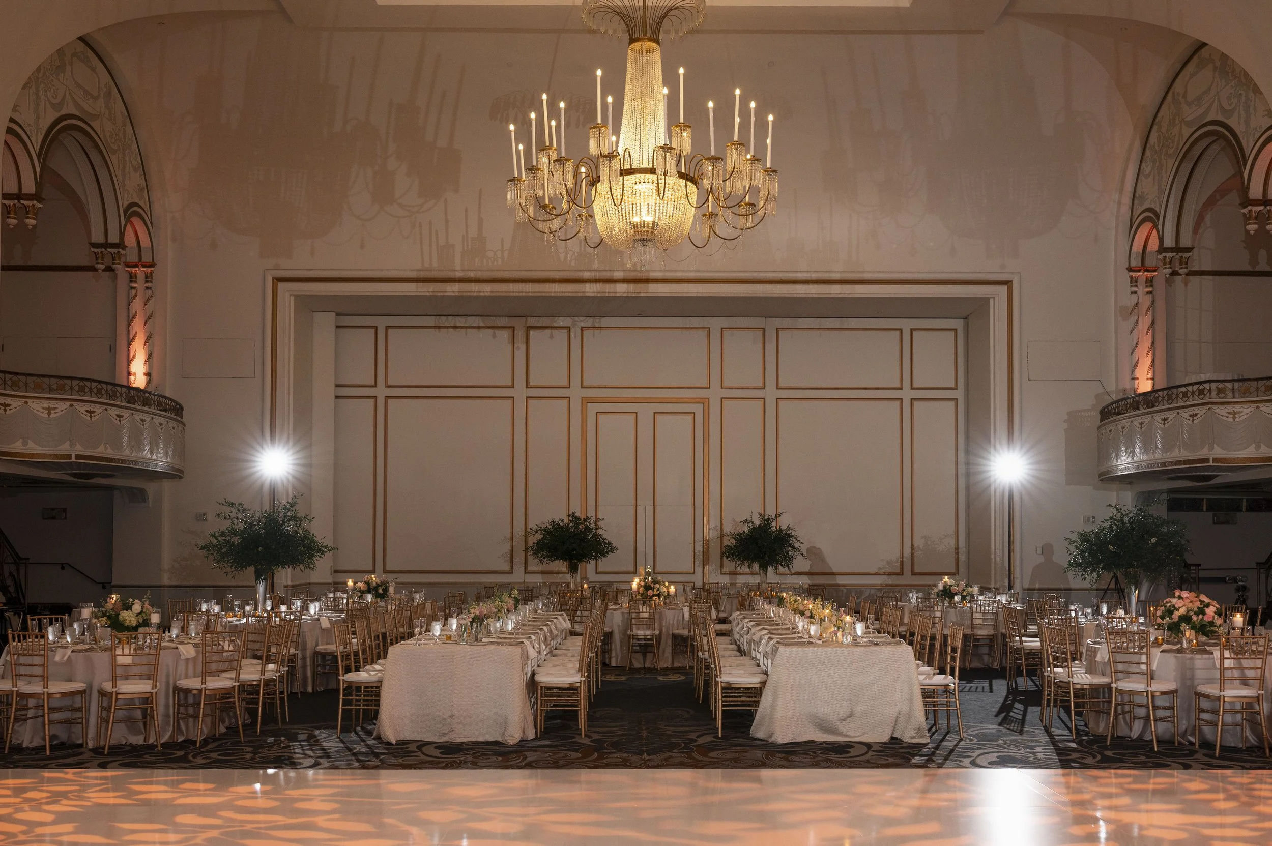 luxiry wedding reception decor at the boston park plaza featuring gold accents, candlelight and romantic florals