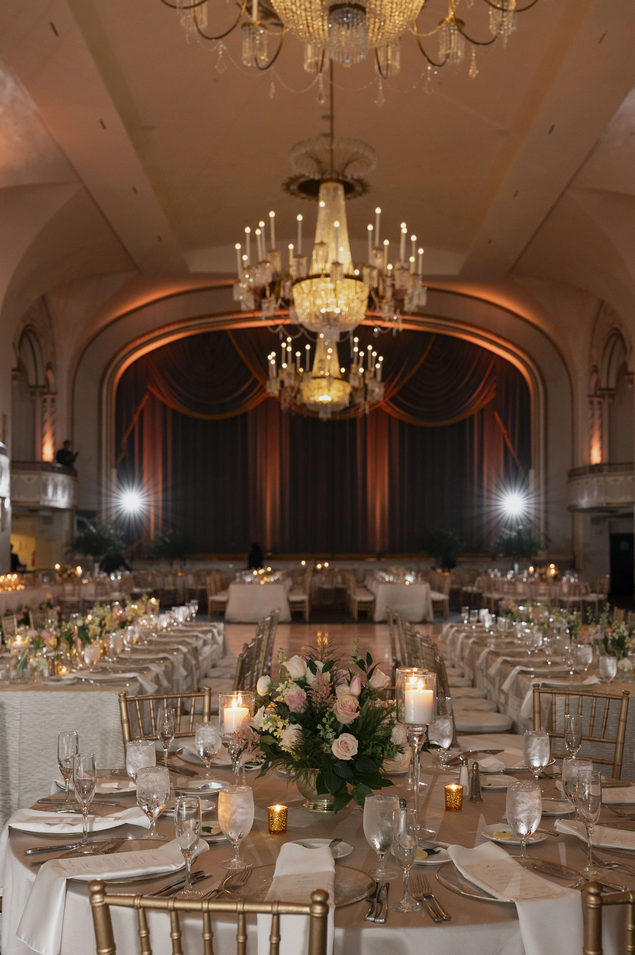 luxiry wedding reception decor at the boston park plaza featuring gold accents, candlelight and romantic florals