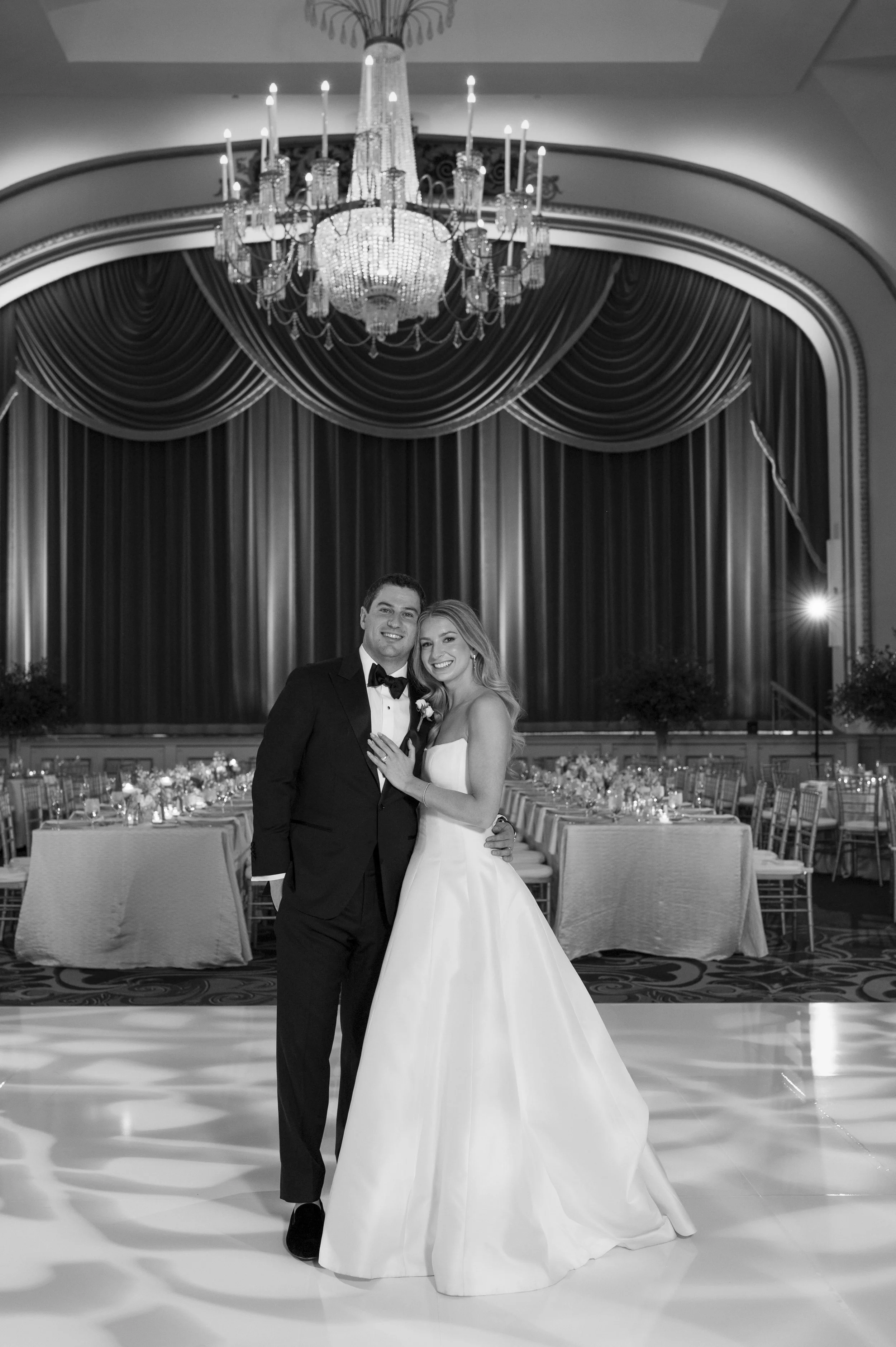 bride and groom posing on the dance floor as they see for the first time their ballroom decor at the boston park plaza