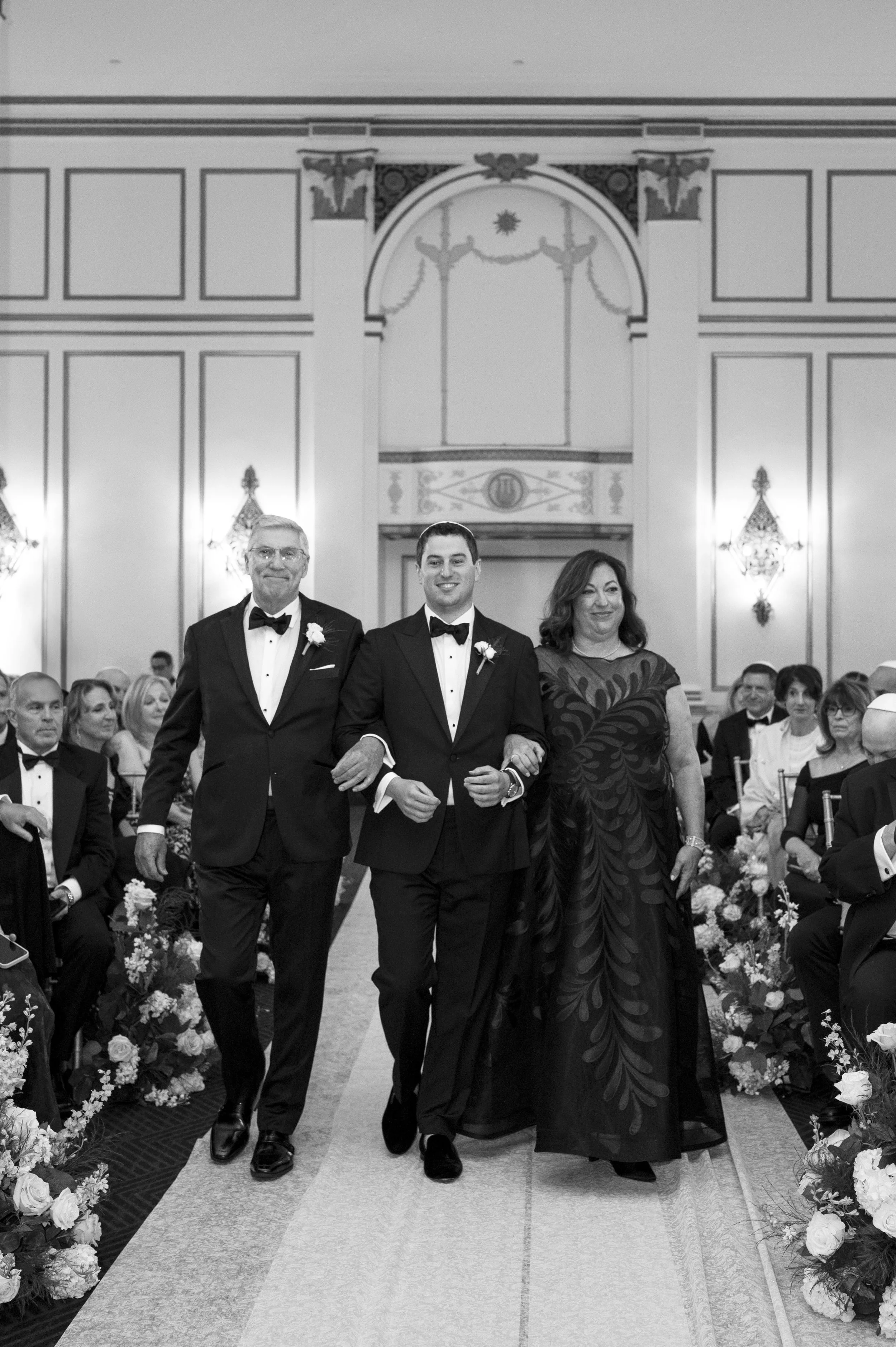 groom walking down the isle with father and mother for a jewish wedding at the park plaza 