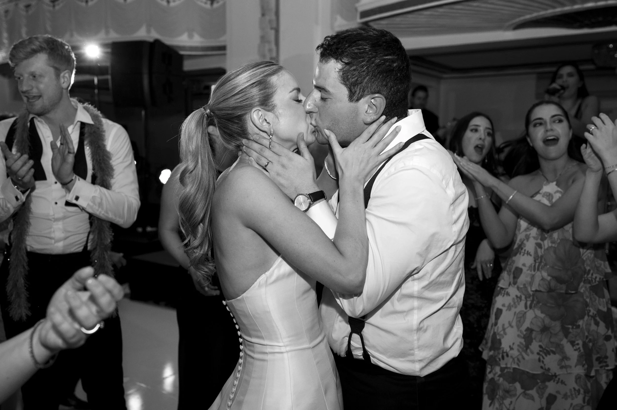 bride and groom kissing in the middle of the dancefloor of their reception at the boston park plaza