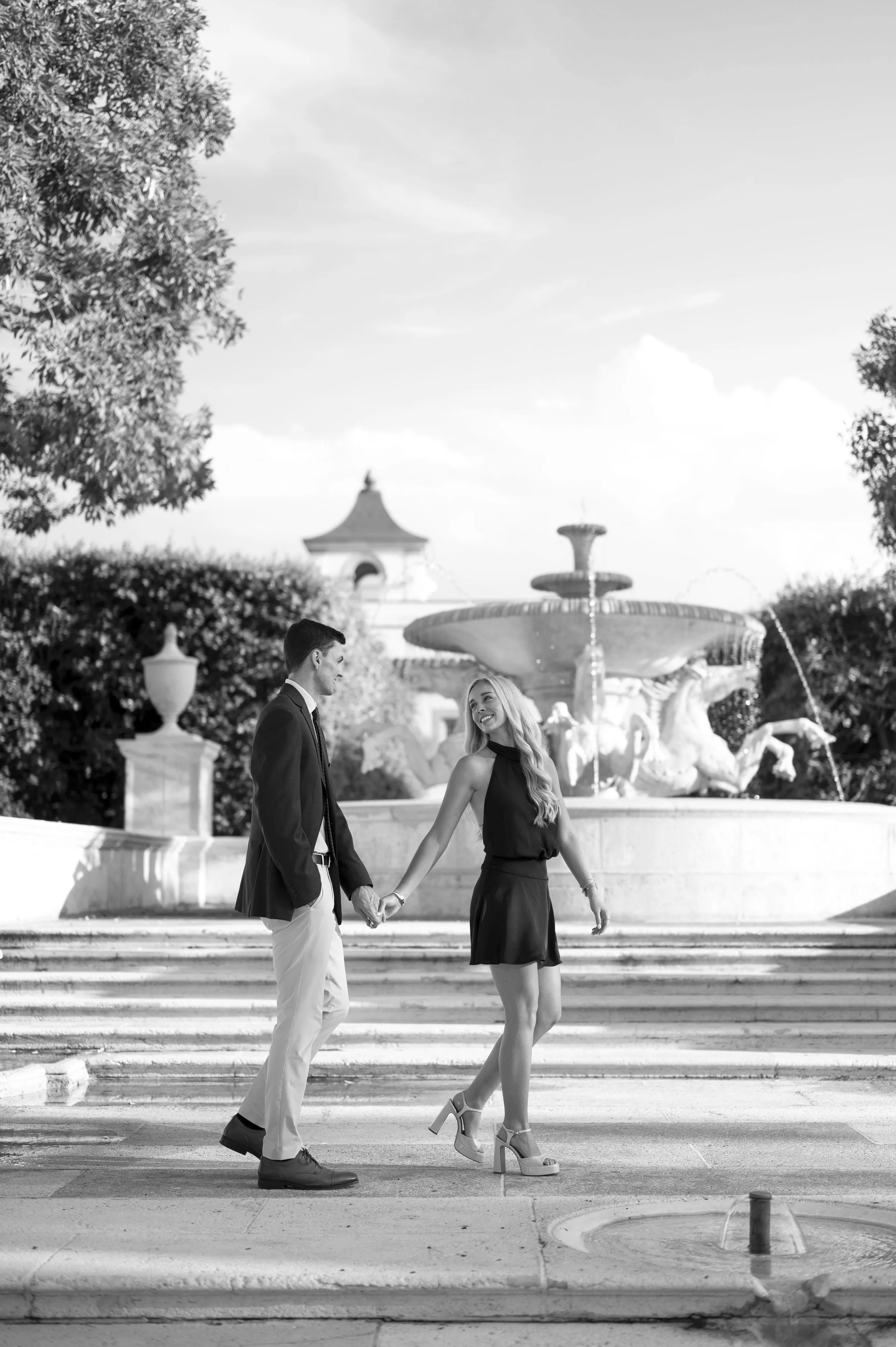 Michael and Mattie walking in front of a fountain as newly engaged (Copy)
