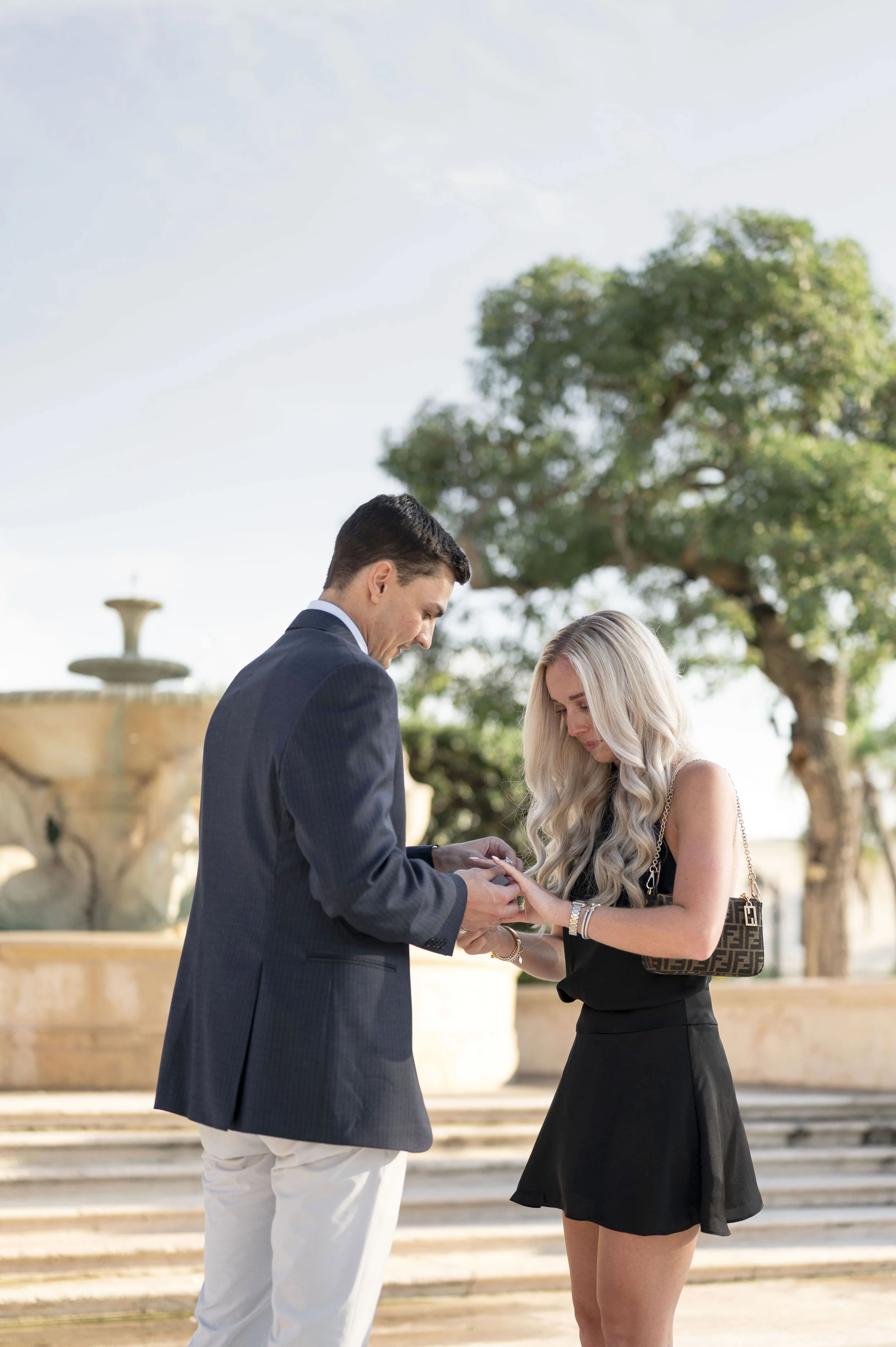 Michael puts on the engagement ring to Mattie's hand (Copy)