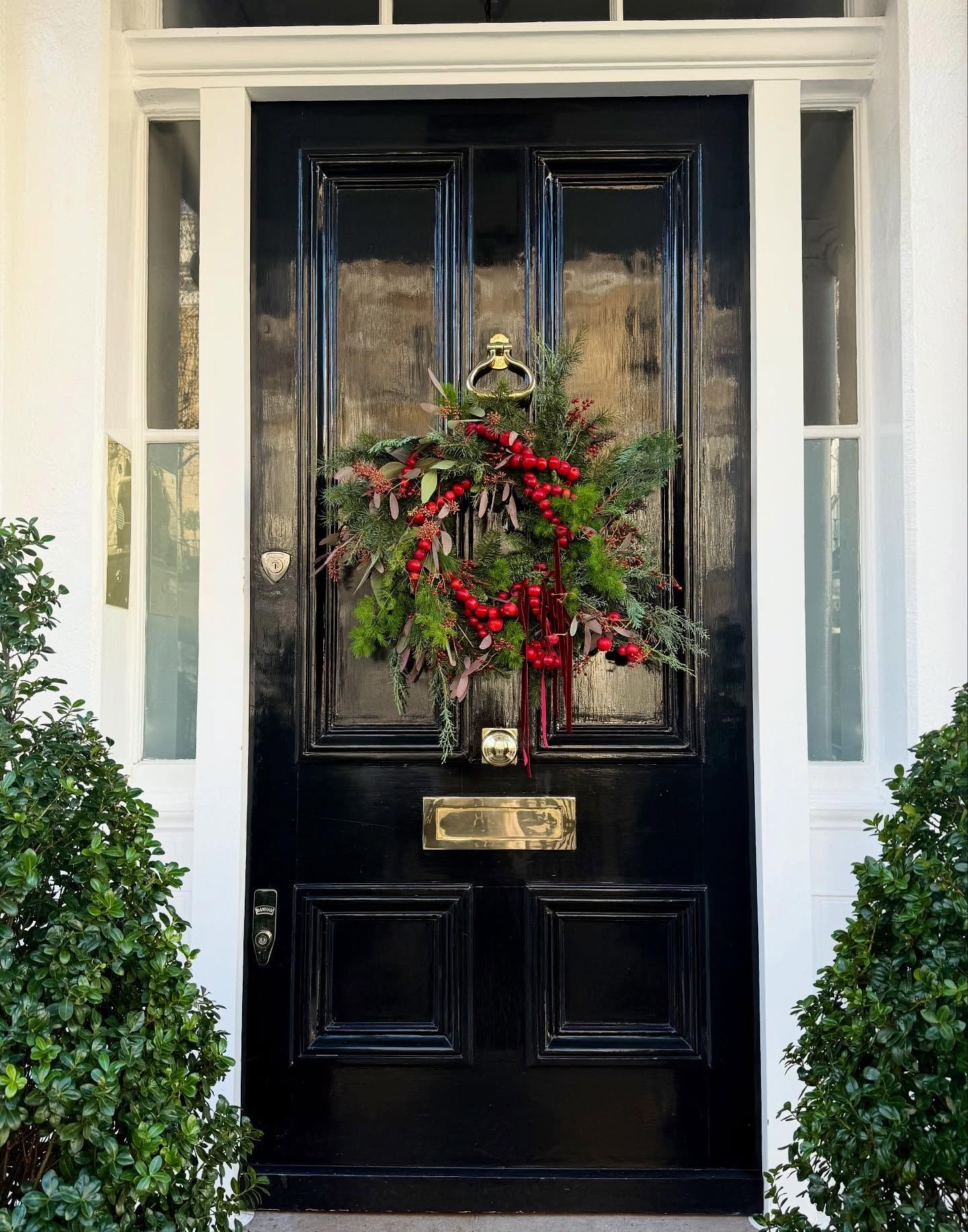 Crabapple Christmas. Loving @billylovesflowers wreath which makes the most of this year&rsquo;s crazy fruit and berry harvest, along with velvet ribbon and pink-toned eucalyptus. #frontdoordecor #londonhouses #designinspᴏ #howwedwell #christmaswreath