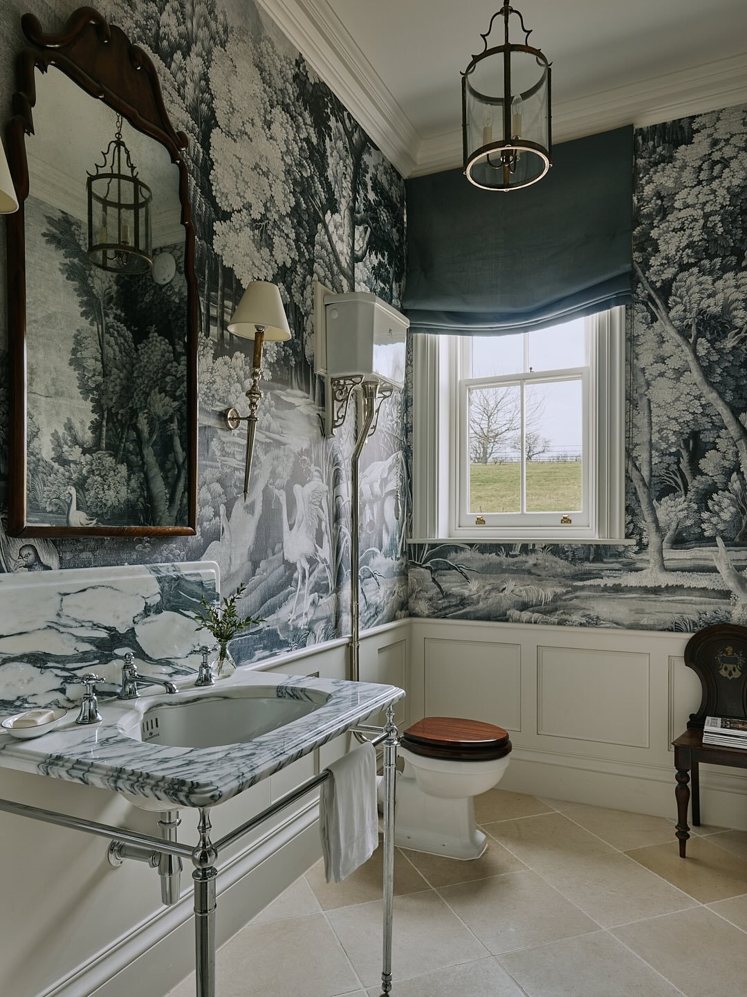 Entering an enchanted forest. We turned the proportions of the tall thin cloakroom in our Oxfordshire manor house project to advantage, by adding panelling and commissioning a bespoke wallpaper based on an old tapestry. So the woodland foliage unfurl