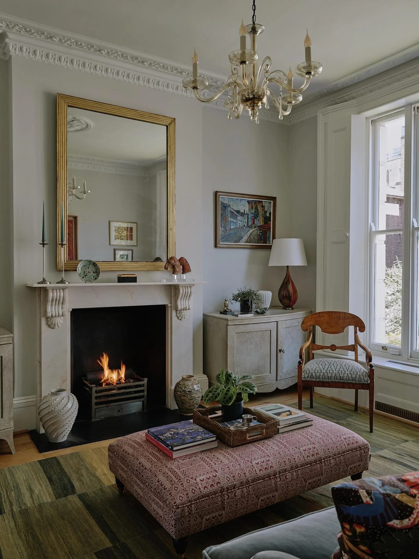 Love a roaring fire on a cold day. The sitting room in one of our London projects which was designed around the clients&rsquo; Soviet era art.  #interiordesign #londonhouses #sittingroomdecor #londoninteriordesigner #designinspiration