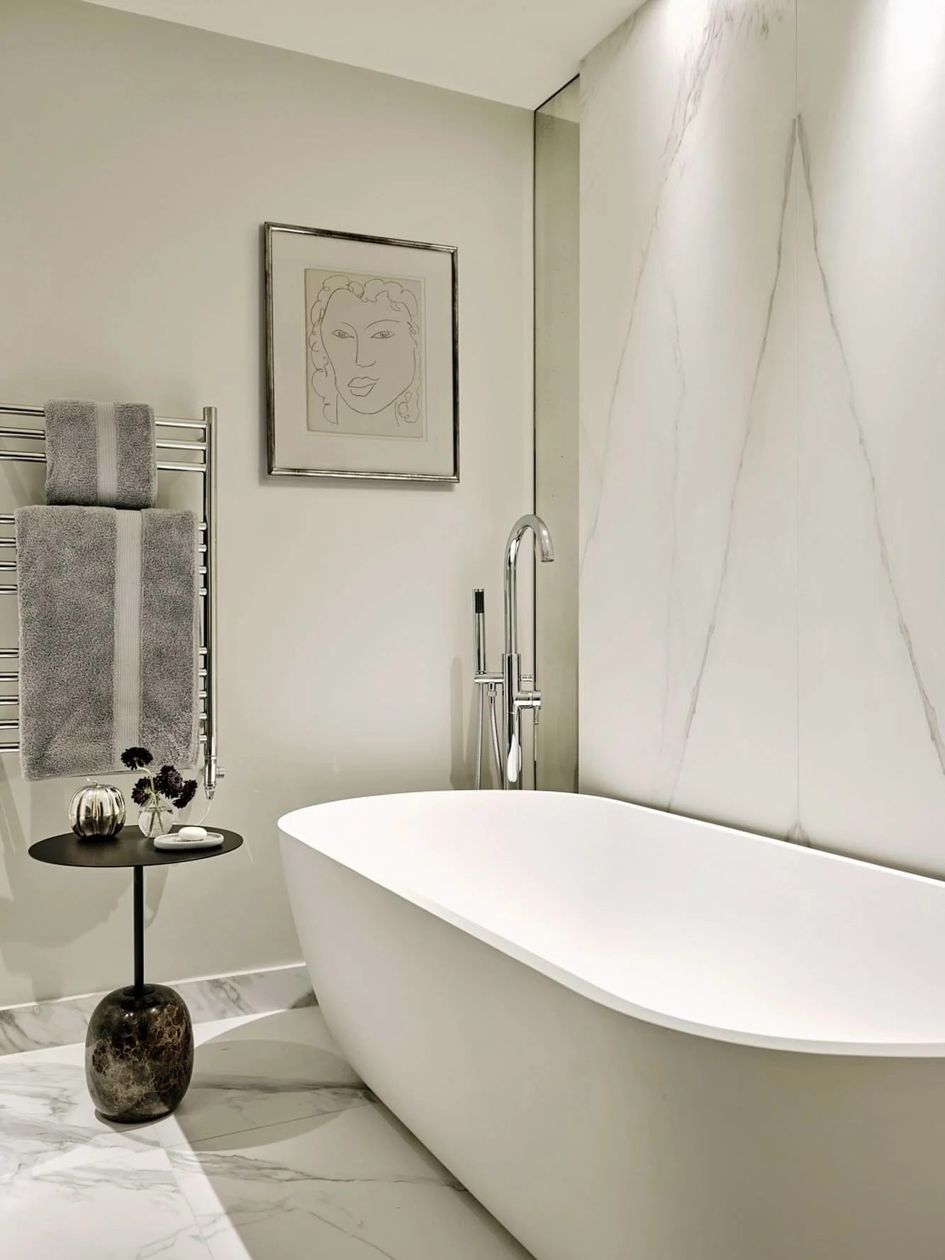 &ldquo;Simplicity is the keynote of all true elegance,&rdquo; Coco Chanel.  Book-matched stone, antiqued mirror and a vintage lithograph by Matisse in the master bathroom of one of our London projects. 📸 @horwoodphoto #interiordesign #bathroomdecor 