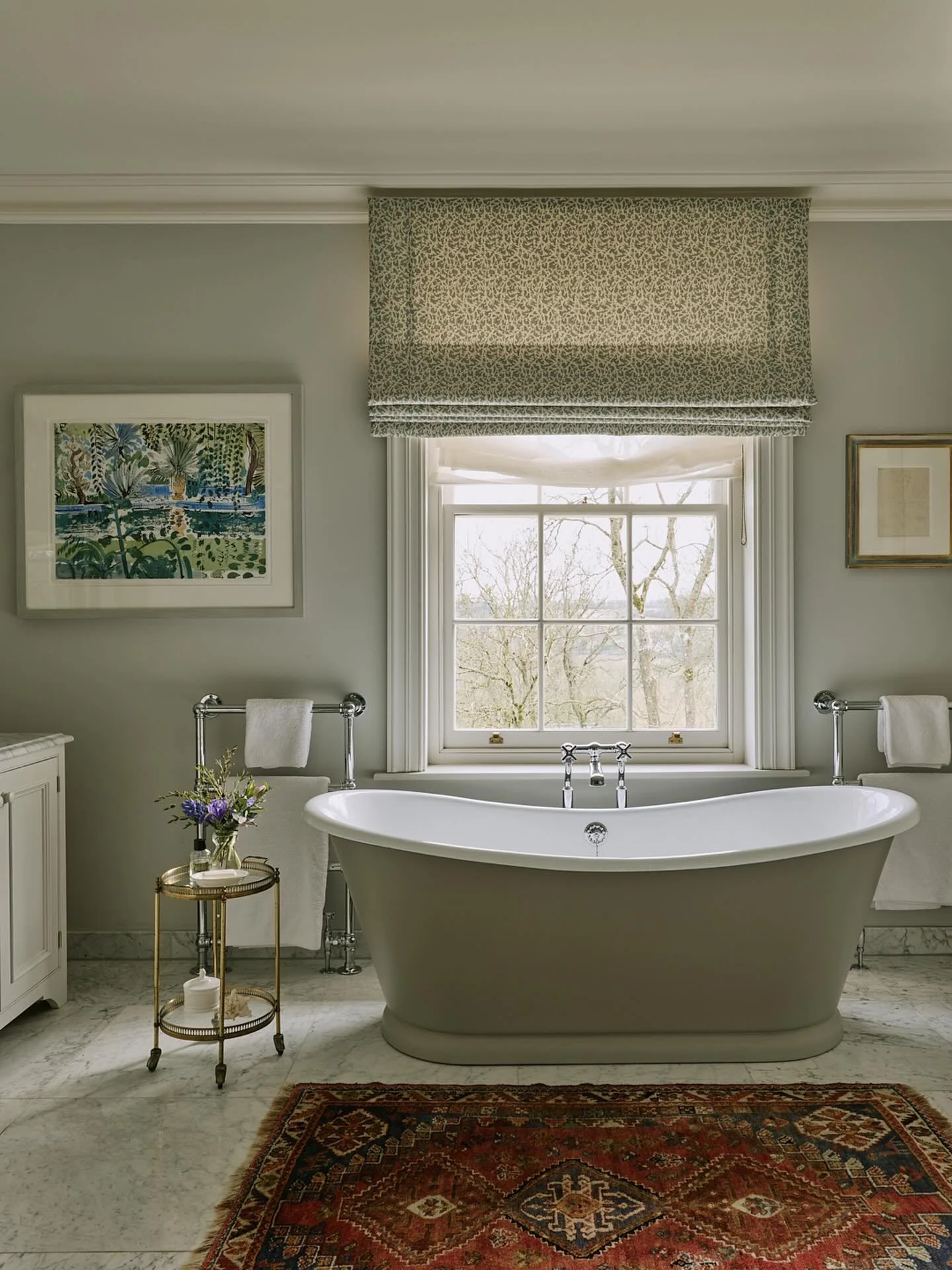 Tranquil country house bathroom looking out onto trees.
The cool blues and greens are set off by a warm Persian rug. #previousproject #countryhousestyle #bathroomdecor #interiorsaddict #bathroomdesign