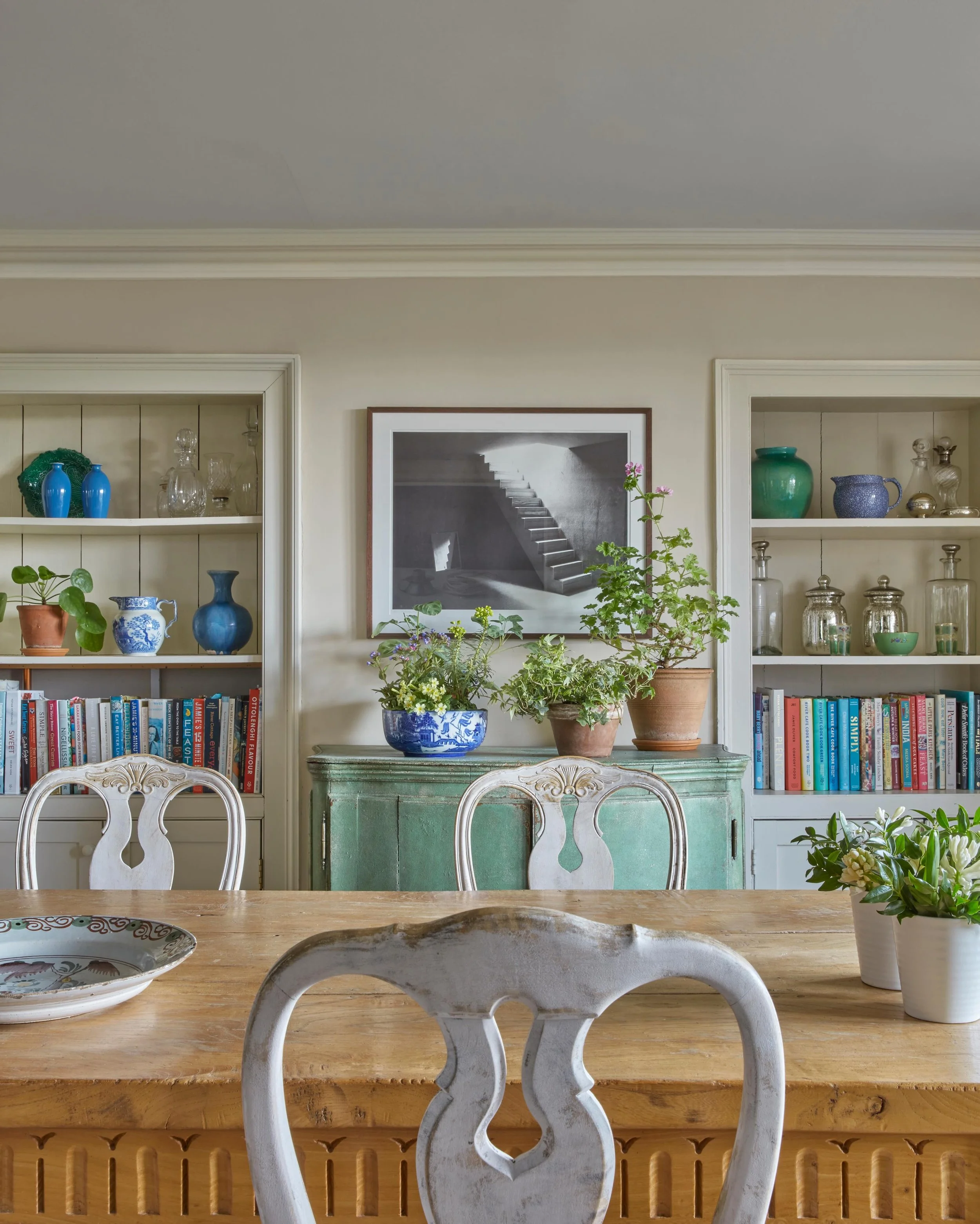 Blue and green should always be seen. A contemporary photograph from the clients&rsquo; art collection contrasts with antique Swedish chairs and blue and white china. The books are all cookery books. 📸@james_mcdonald_photography #kitchendecor #inter