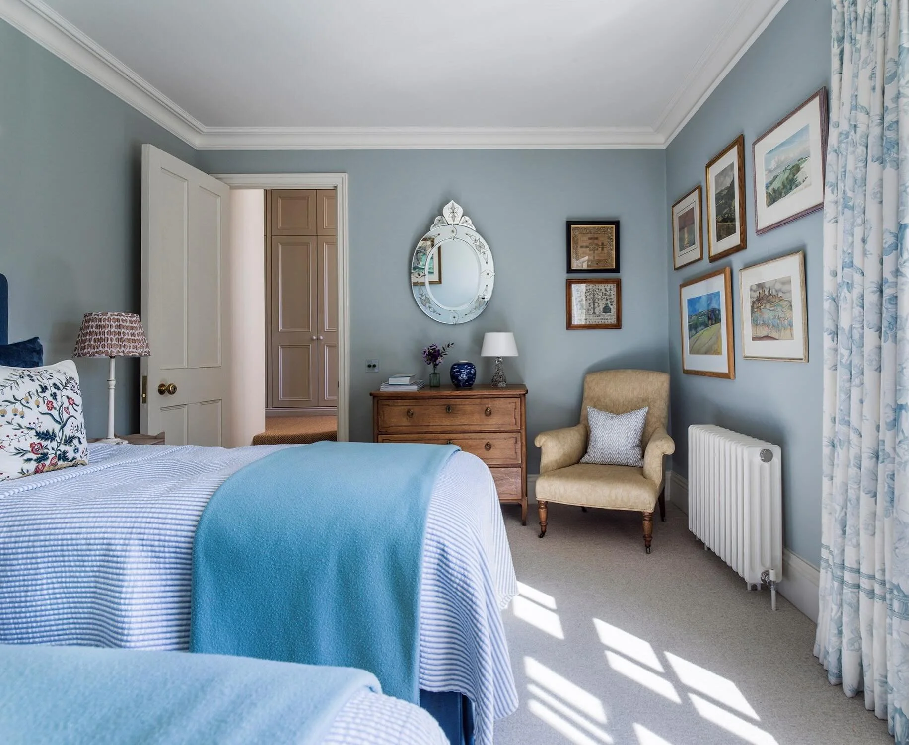 Feeling summery in this tranquil bedroom with its gallery wall of English watercolours and Venetian mirror. #previousproject #countryhousestyle #bedroomdecor #interiorsaddict