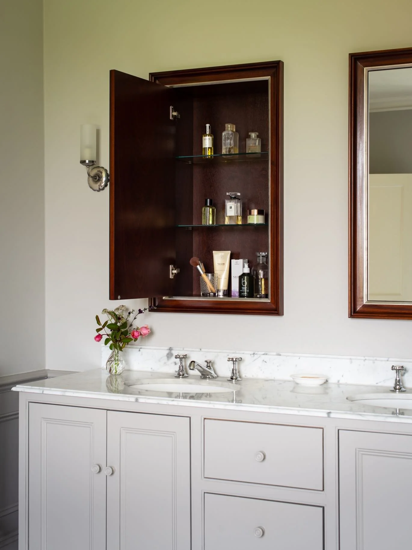 Hidden treasure. We designed these mirrored cabinets with mahogany and distressed silver gilt frames using the depth of the partition wall for concealed storage. The doors are on push catches - swipe right and you&rsquo;ll see that they are completel