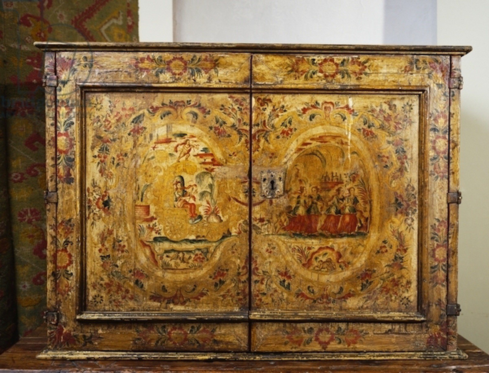 Painted cabinet depicting scene with Jupiter's chariot being pulled by girls and floral motifs