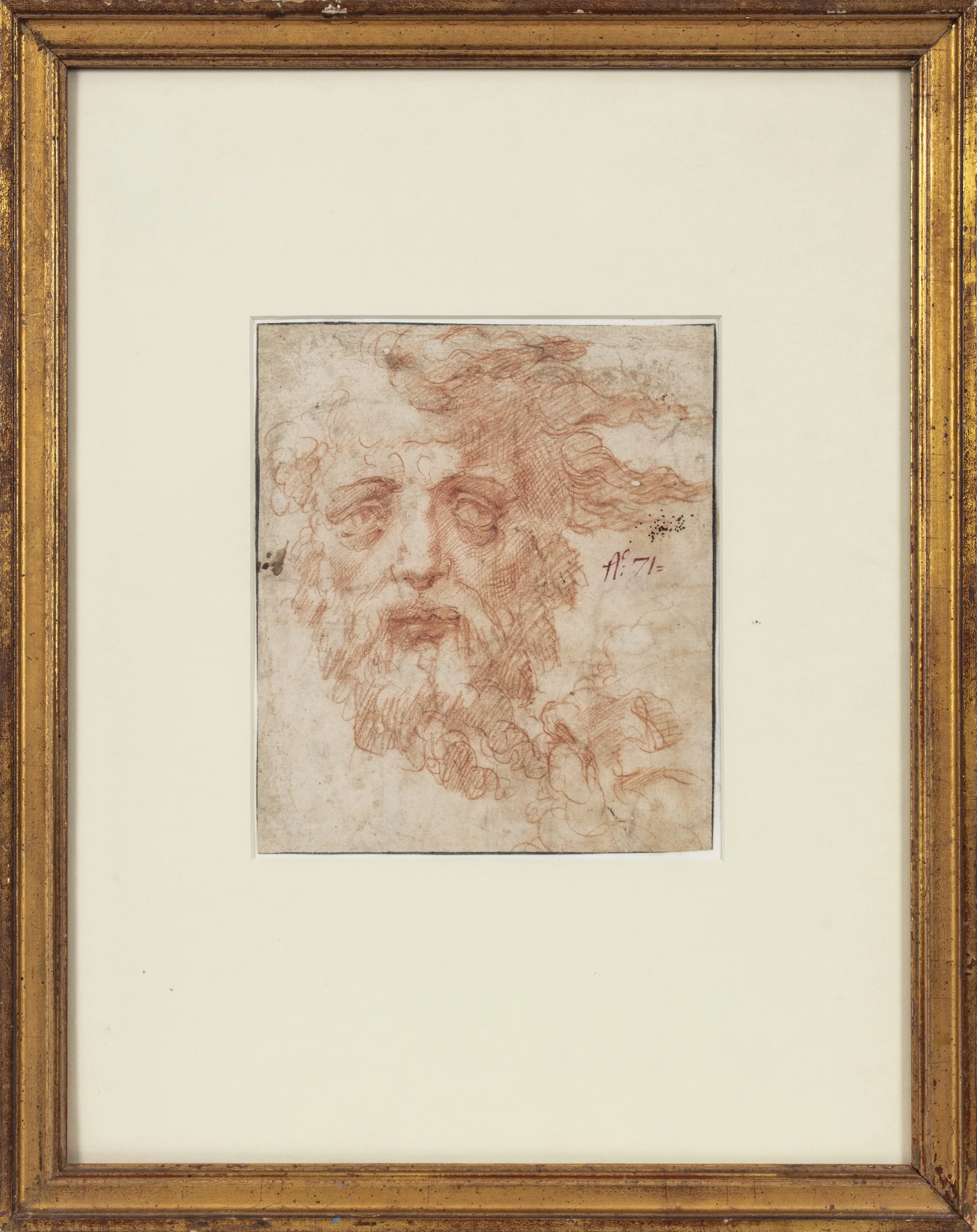 Red colored sketch of an old man's head in a gold frame.