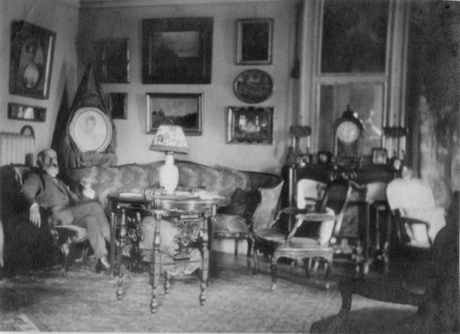 Family photograph showing Viktor Goriany in his Paris apartment with the present watercolor on the wall