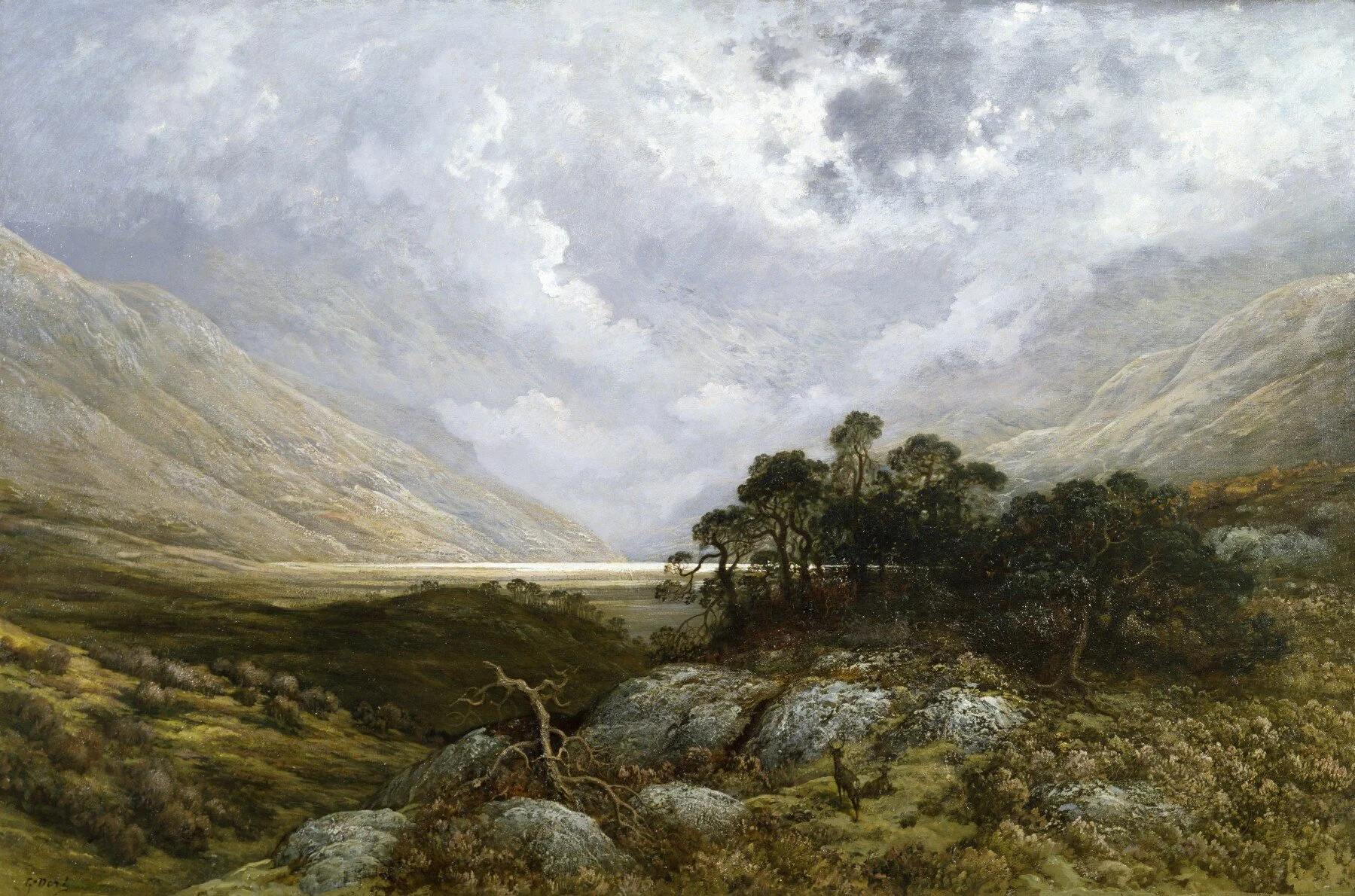 Clear and stormy sky above mountains and a copse.