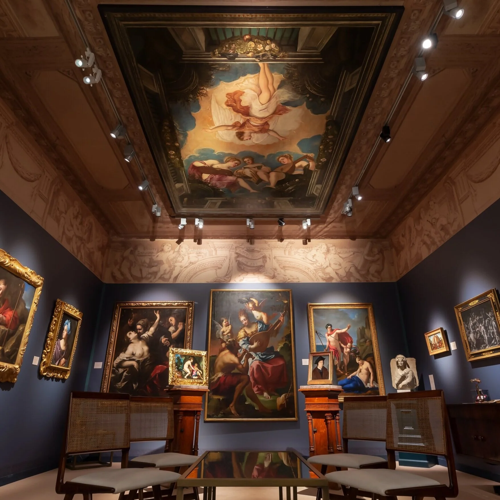 Main view of booth with ceiling decorated with artwork for sale.