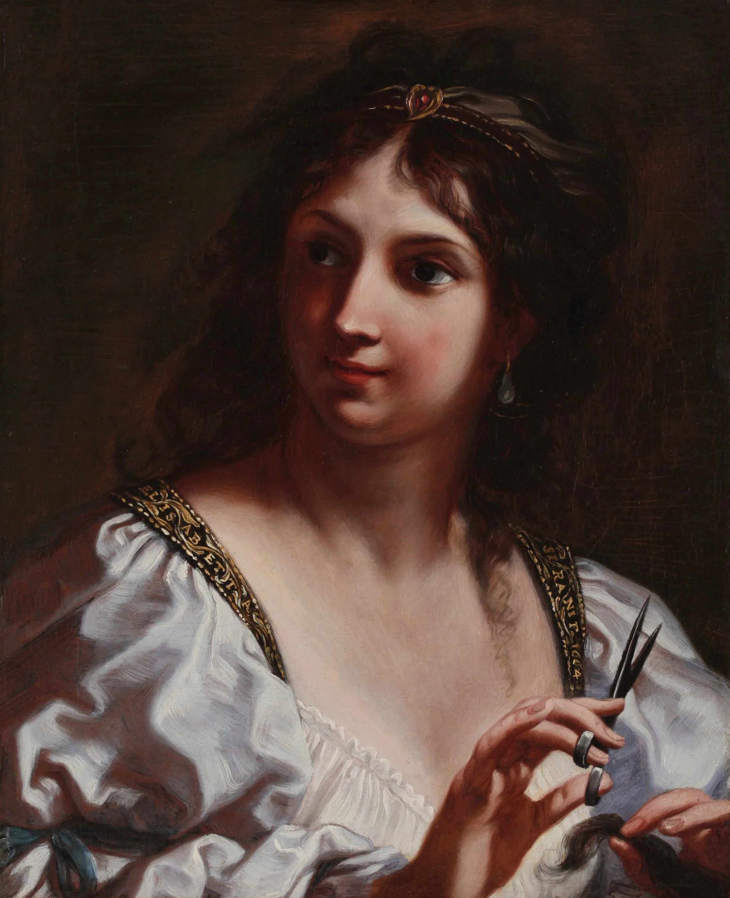 A young woman holds a lock of hair in her left hand, and a pair of scissors in her right.